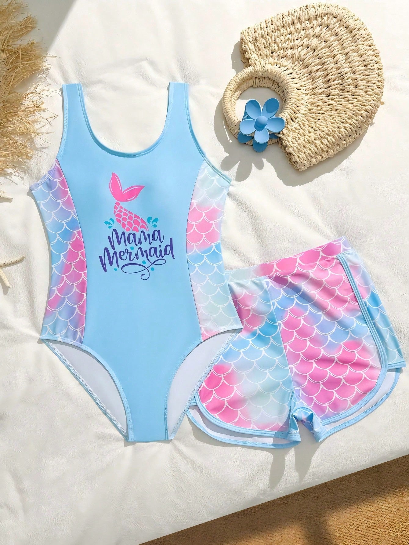 Tween girls 2-piece swimsuit set in black with full floral and plant print, featuring a sleeveless scoop-neck swim top and matching shorts-style bottoms.