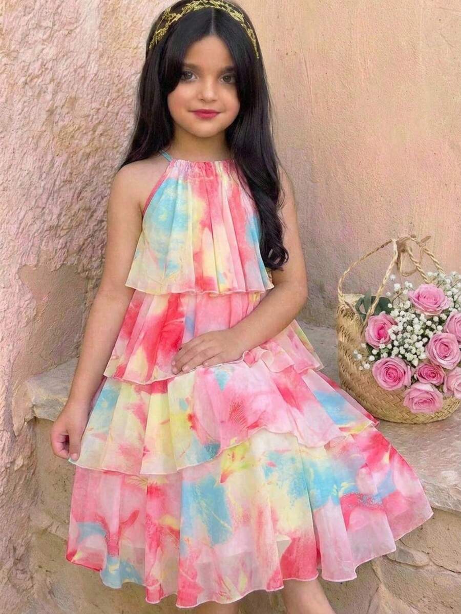 Apricot all-over floral print midi dress for tween girls featuring a sleeveless V-neckline, high waist, button details, and tiered A-line skirt.