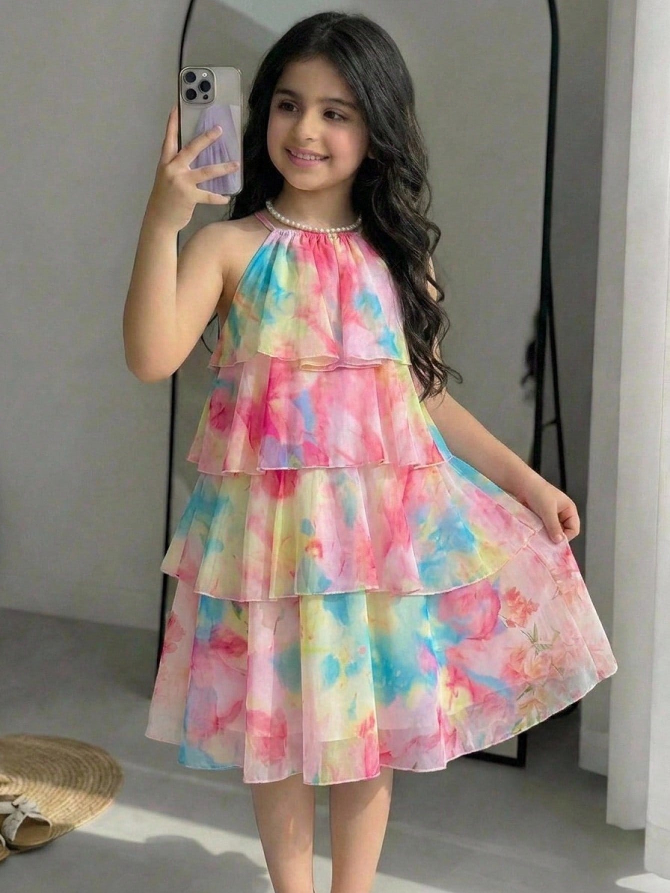 Apricot all-over floral print midi dress for tween girls featuring a sleeveless V-neckline, high waist, button details, and tiered A-line skirt.