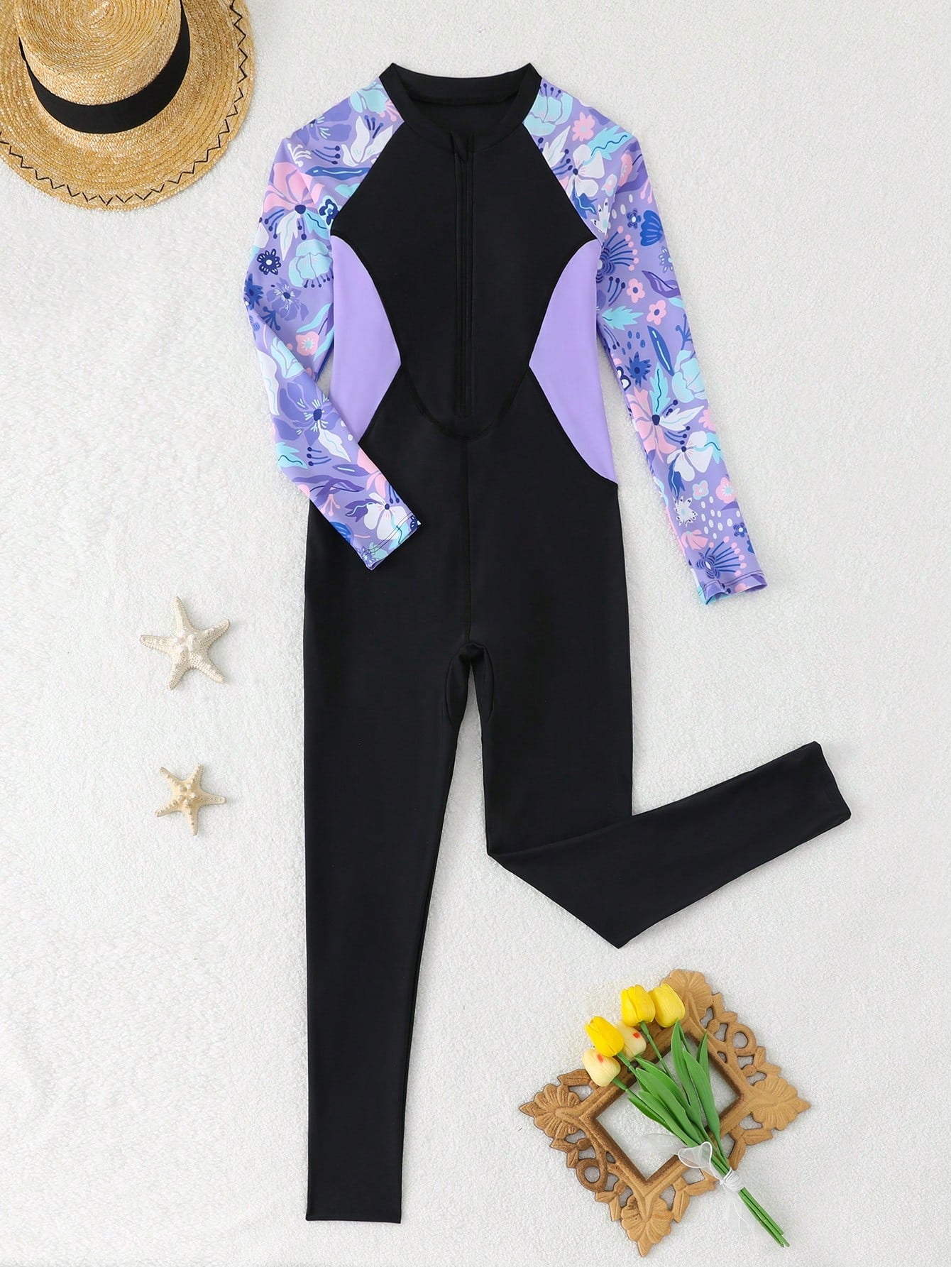 Tween girls black one-piece swimsuit with long sleeves, high neck, zipper detail, graphic leopard heart print, and fitted full-coverage swimwear style.