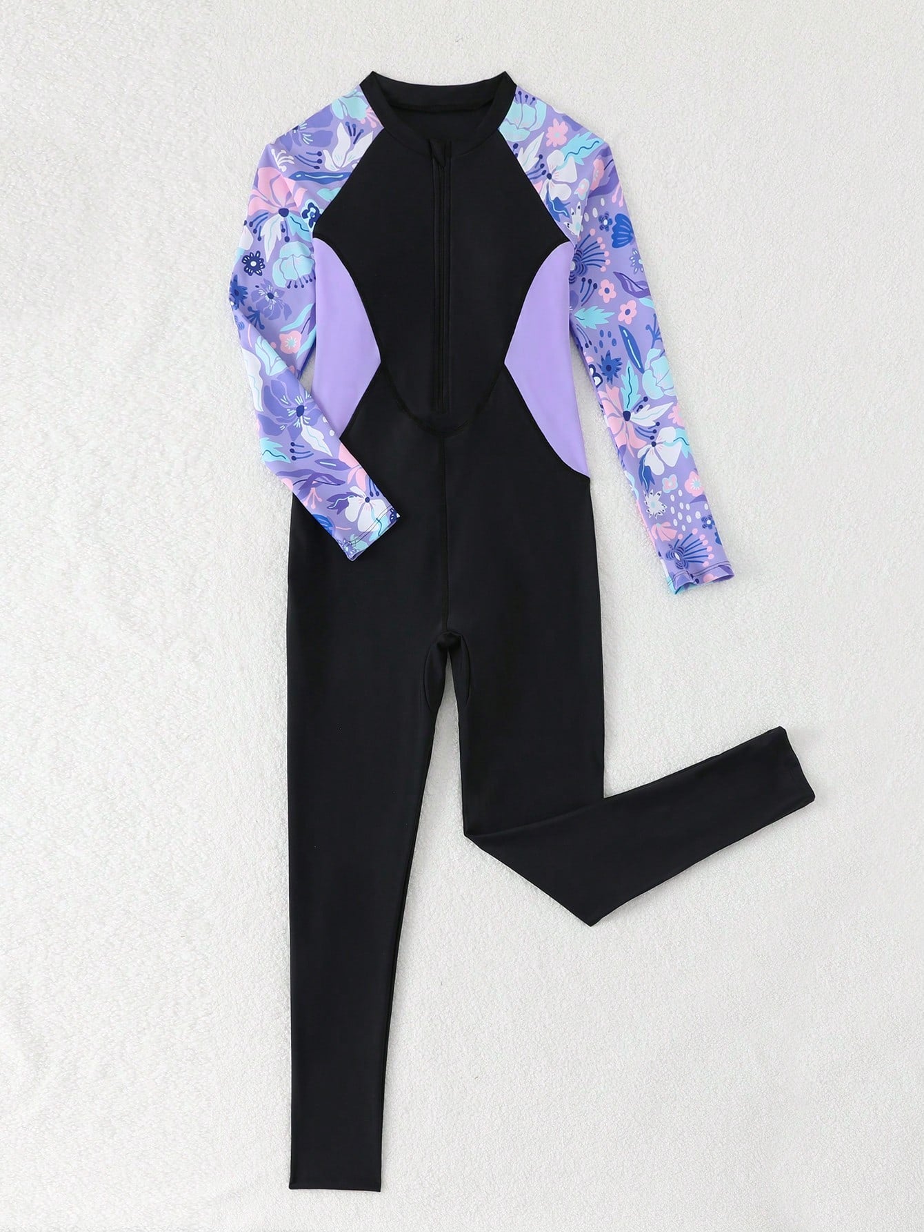 Tween girls black one-piece swimsuit with long sleeves, high neck, zipper detail, graphic leopard heart print, and fitted full-coverage swimwear style.