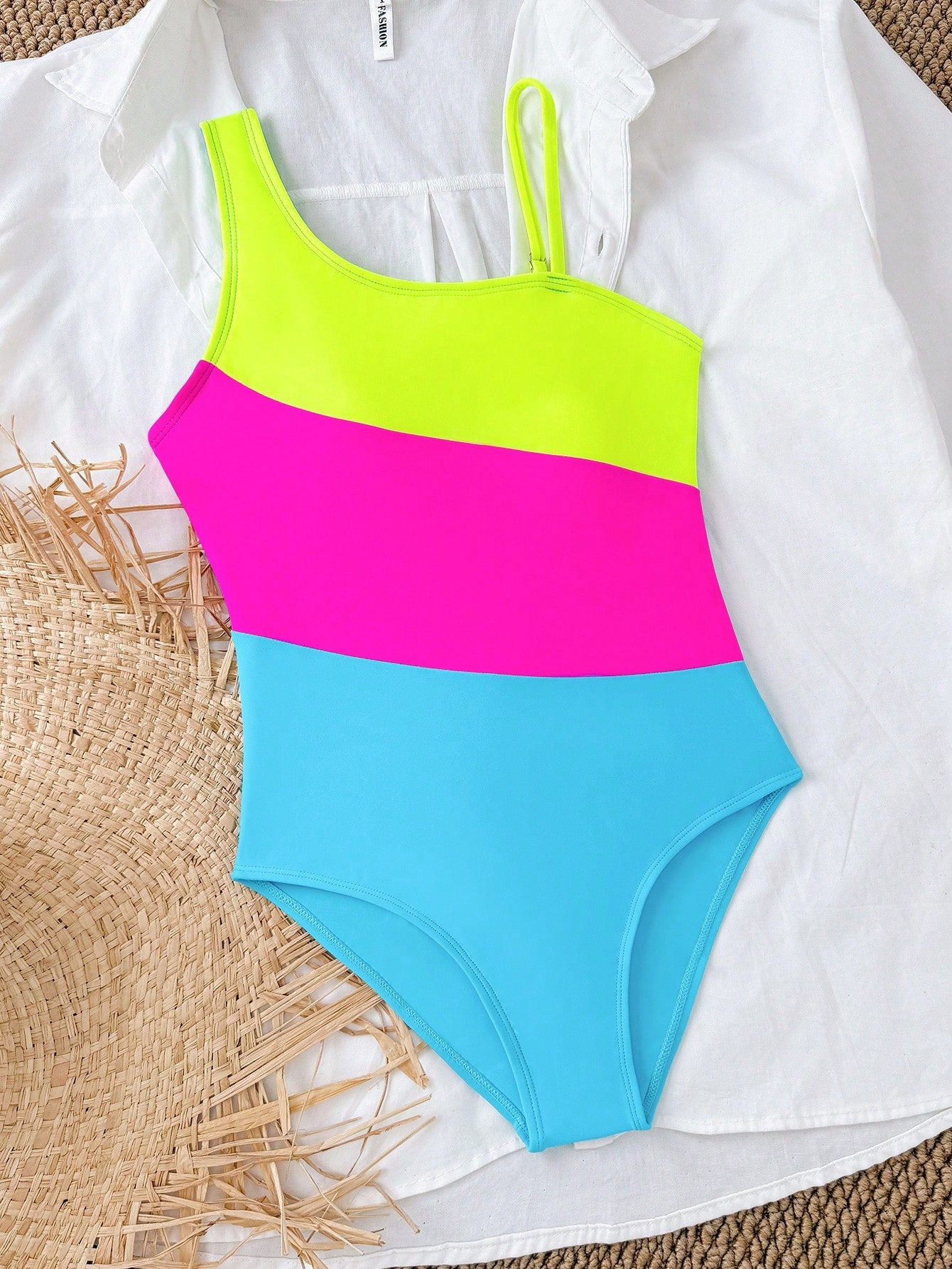 Black one-piece swimsuit for tween girls with cut out detail, spaghetti straps, high waist bottom, wireless bra, and fitted vacation swimwear style.