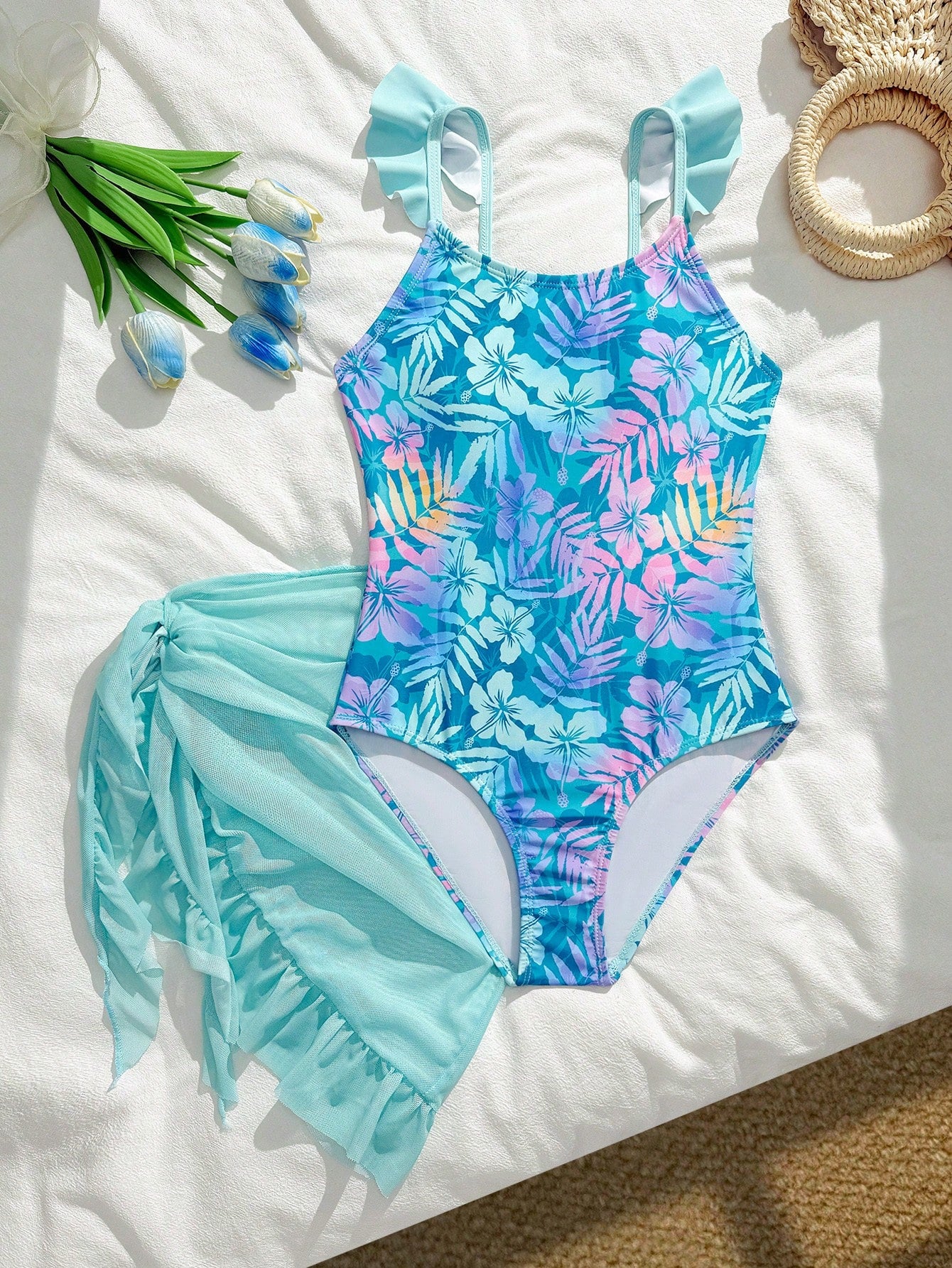 Tween girls one-piece swimsuit in leopard print with ruffle shoulder straps, scoop neckline, fitted shape, and attached ruffle hem skirt; sleeveless, mid-waist skirt bottom, and lined body for swimming, vacation, and summer beach wear.