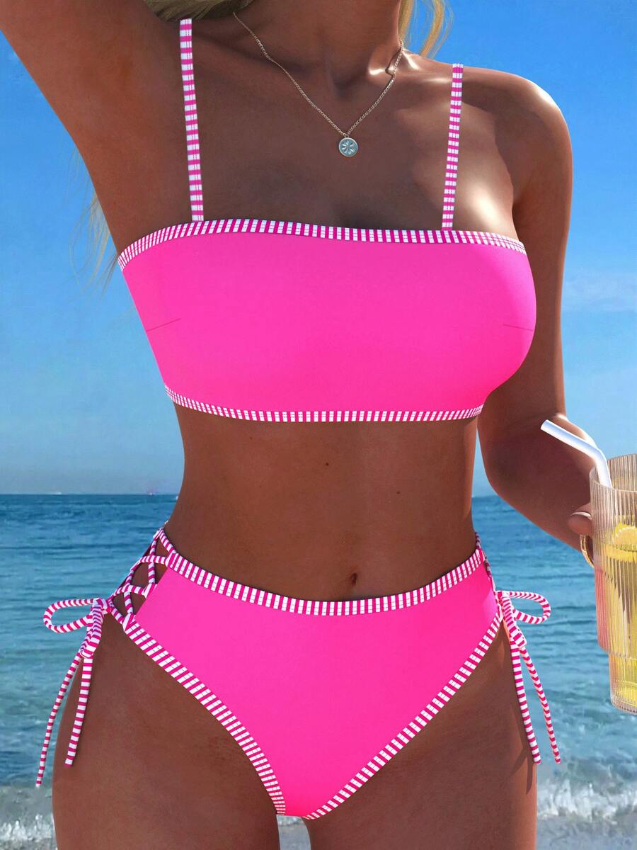 Women's hot pink split bikini set featuring a high waist tie-side bottom and a wireless bandeau top with criss cross details.