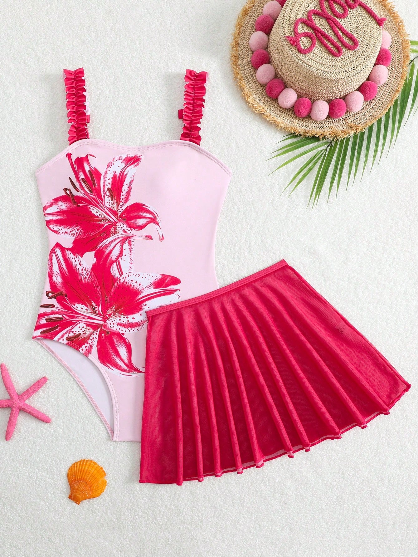 Girls floral print swimsuit set with strap neckline, sleeveless fitted top, and pleated mesh skirt bottom for beach and summer vacation wear.