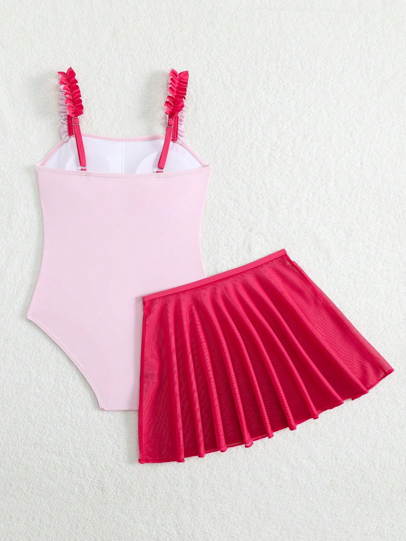 Girls floral print swimsuit set with strap neckline, sleeveless fitted top, and pleated mesh skirt bottom for beach and summer vacation wear.