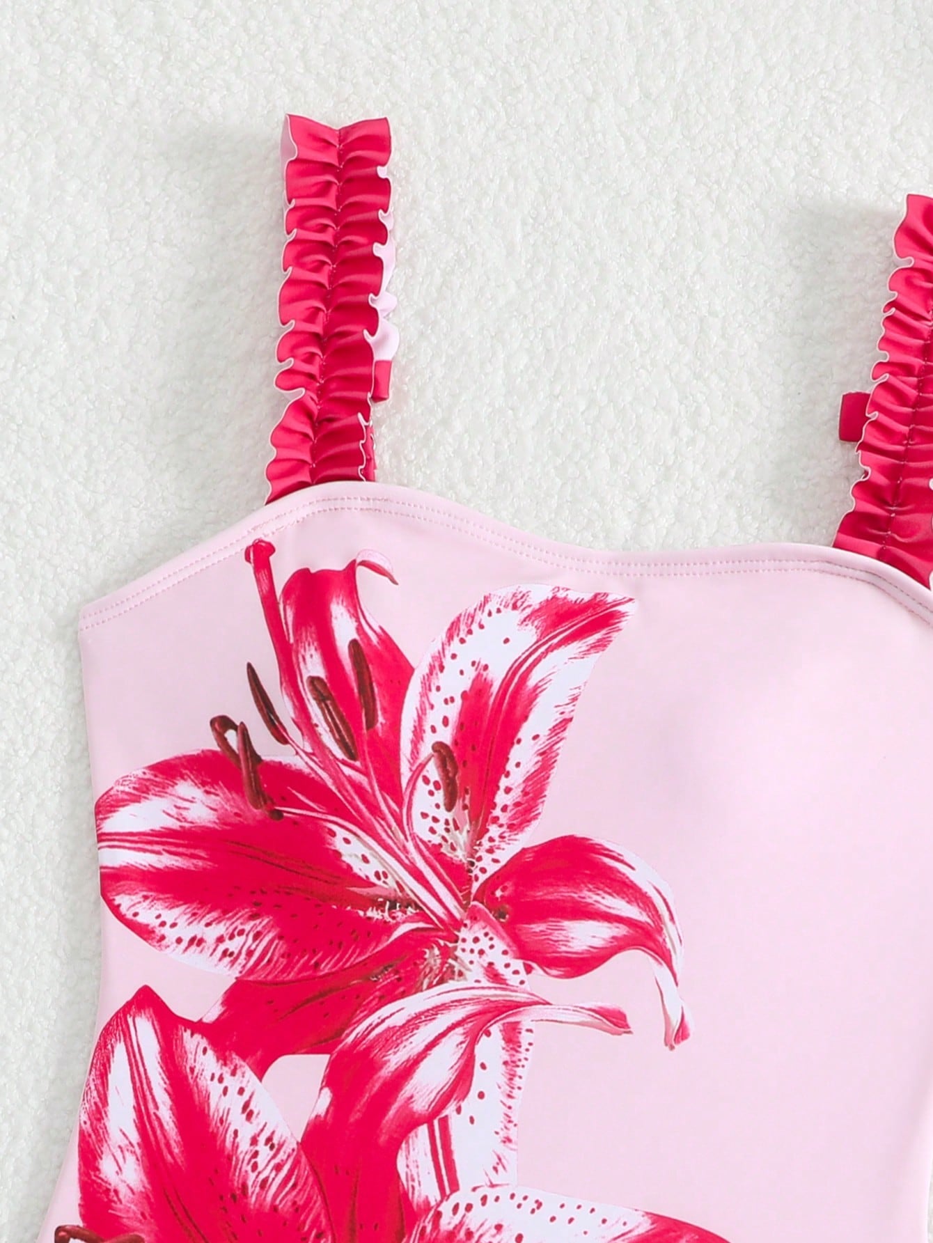 Girls floral print swimsuit set with strap neckline, sleeveless fitted top, and pleated mesh skirt bottom for beach and summer vacation wear.