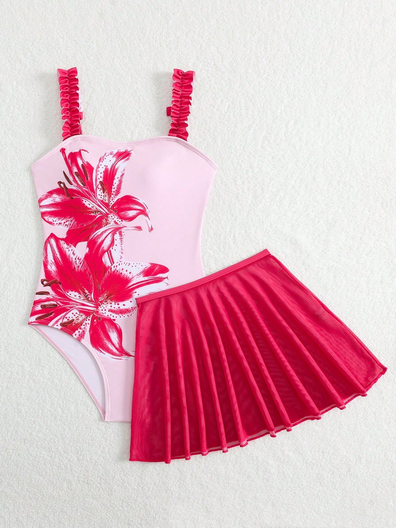 Girls floral print swimsuit set with strap neckline, sleeveless fitted top, and pleated mesh skirt bottom for beach and summer vacation wear.