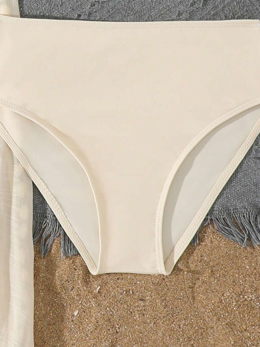 Beige 3-piece swimwear set for tween girls featuring an asymmetrical ruffle top with contrast lace trim, plant pattern, and mid-waist bikini bottoms.