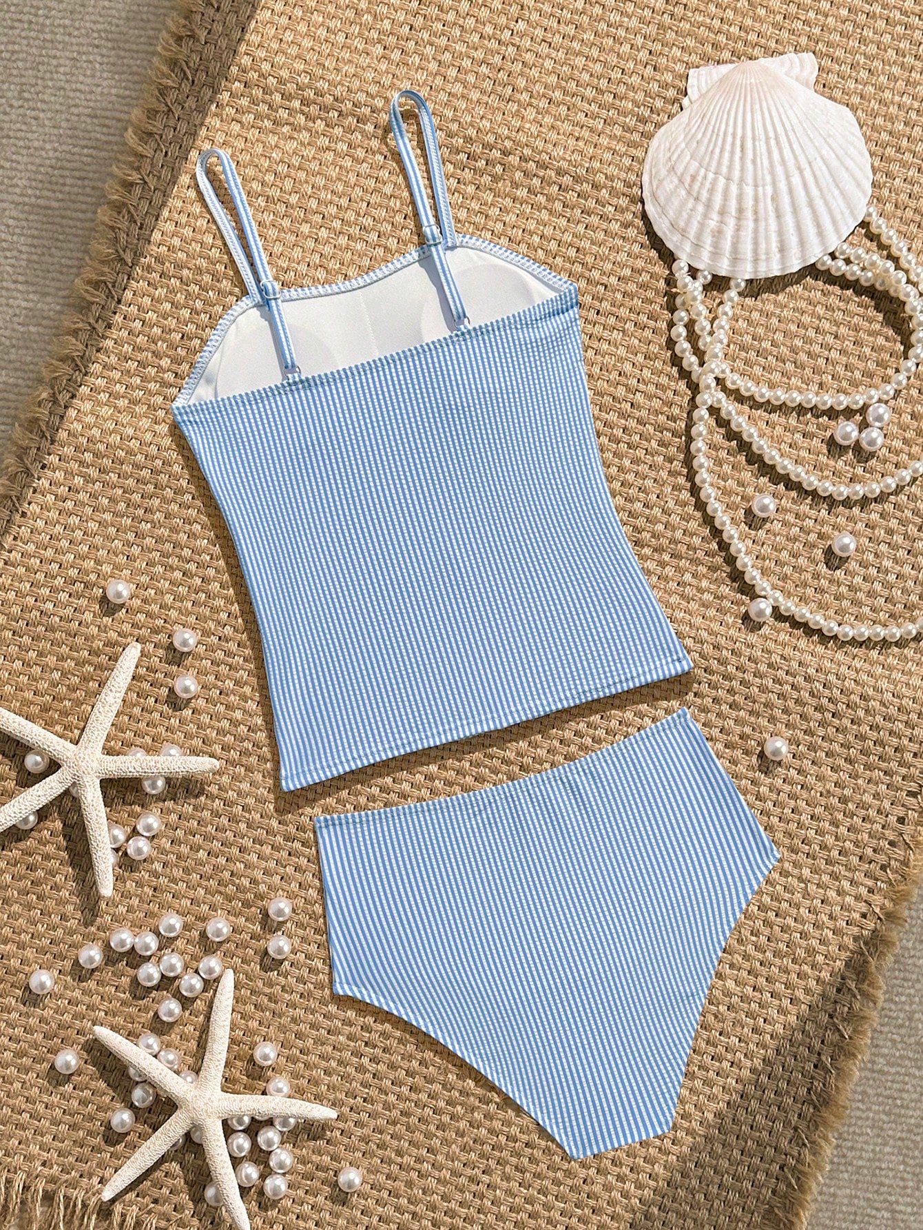 Tween girls 2-piece bikini swimwear set in black with a wave-pattern geometric design, featuring halter neckline, wireless top, and high-waist short bottoms with starfish and shell decor.