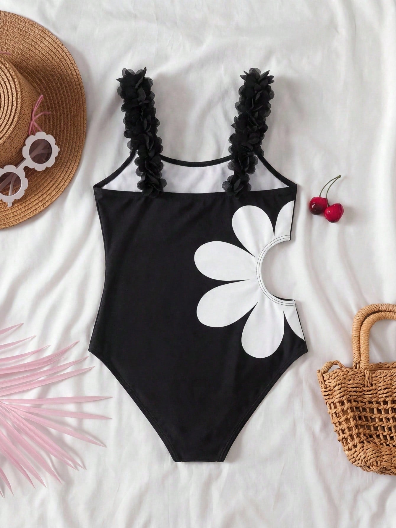 Tween girls' black one-piece swimsuit with floral patchwork all-over print, 3D rose detail, scoop neckline, fitted shape, and lined body for beach and vacation swimwear.