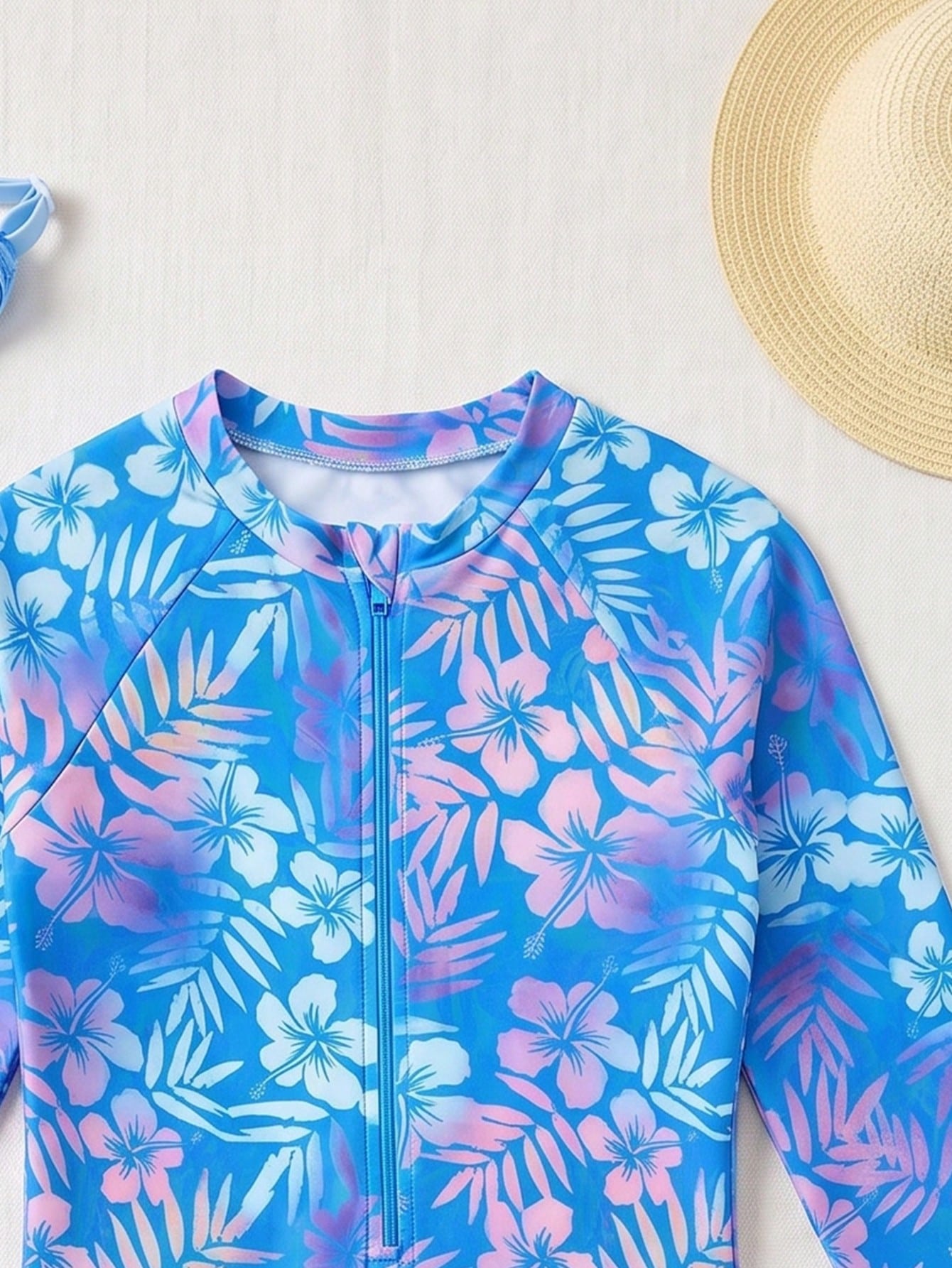 Girls' floral one-piece swimsuit with ruffle trim, high neck, and zipper front for beach and resort wear