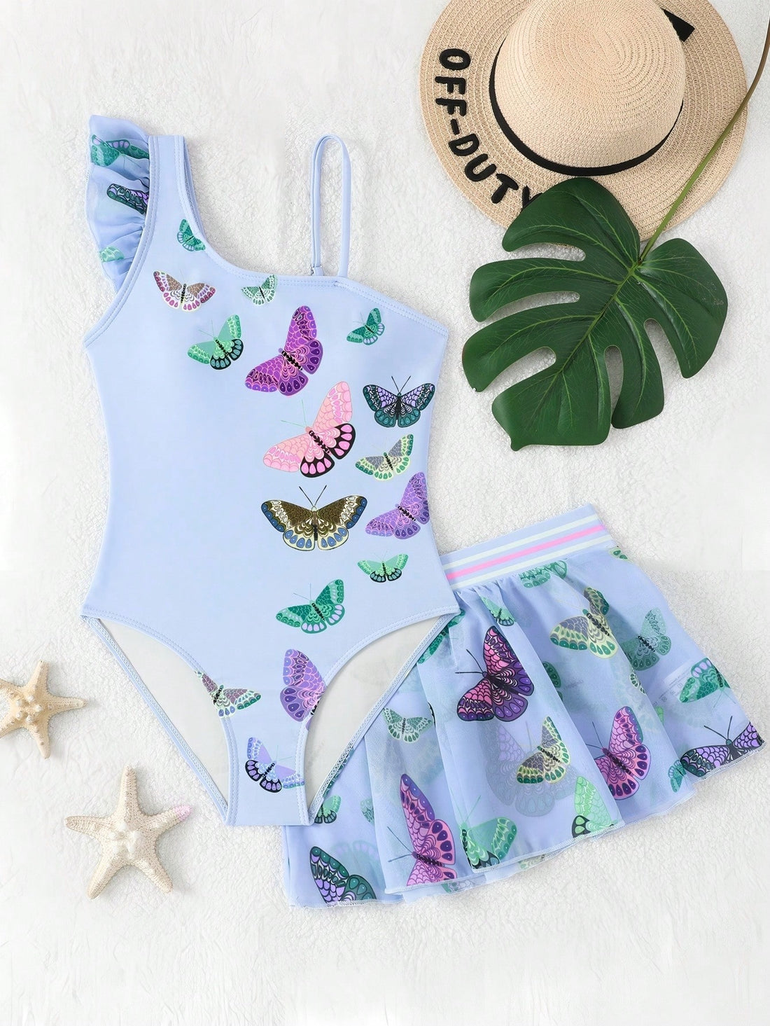 Girls yellow one-piece swimsuit with asymmetrical neckline, ruffle detail, sleeveless fitted style, and skirt bottom for beach and pool vacations.