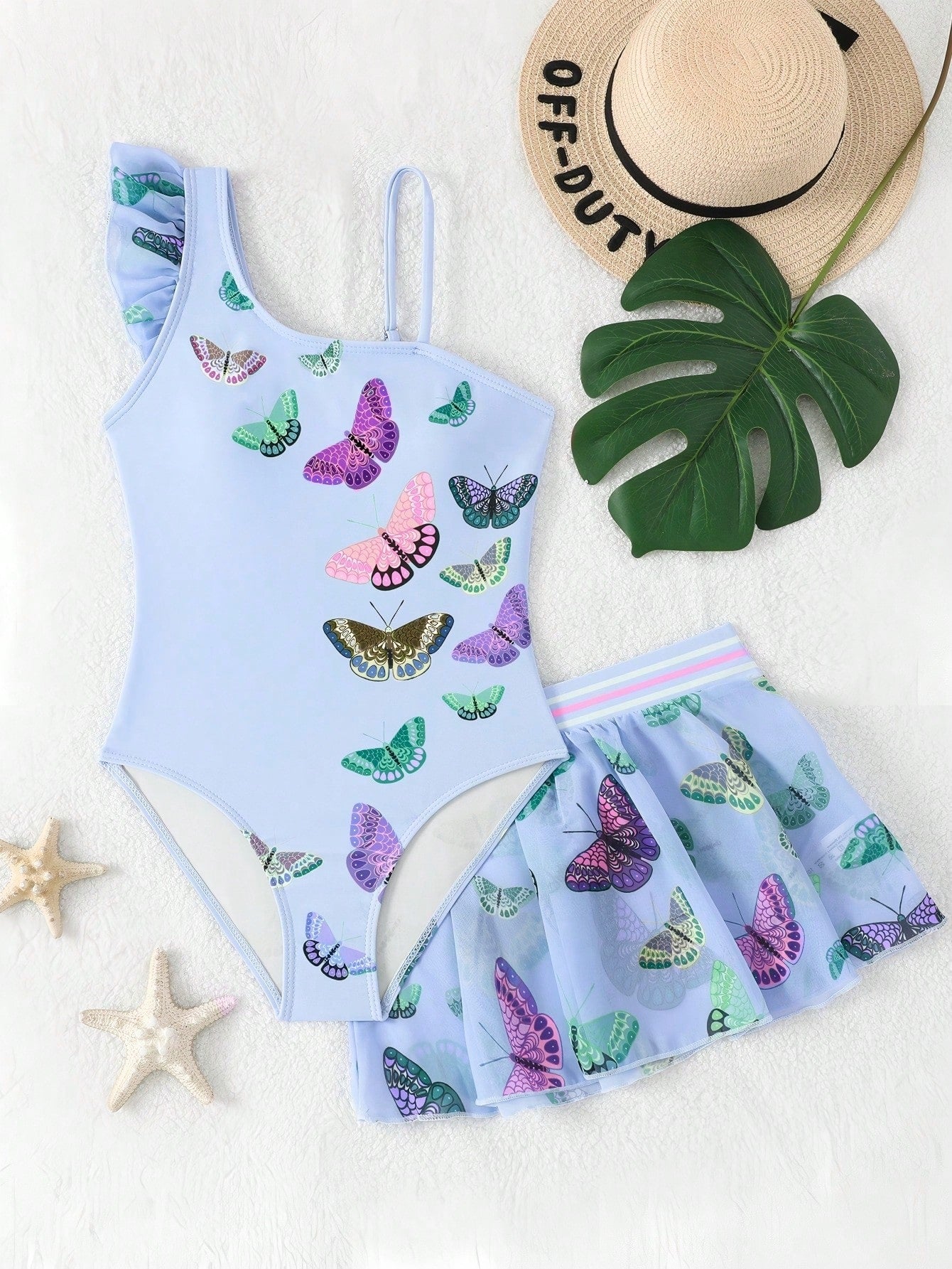 Girls yellow one-piece swimsuit with asymmetrical neckline, ruffle detail, sleeveless fitted style, and skirt bottom for beach and pool vacations.