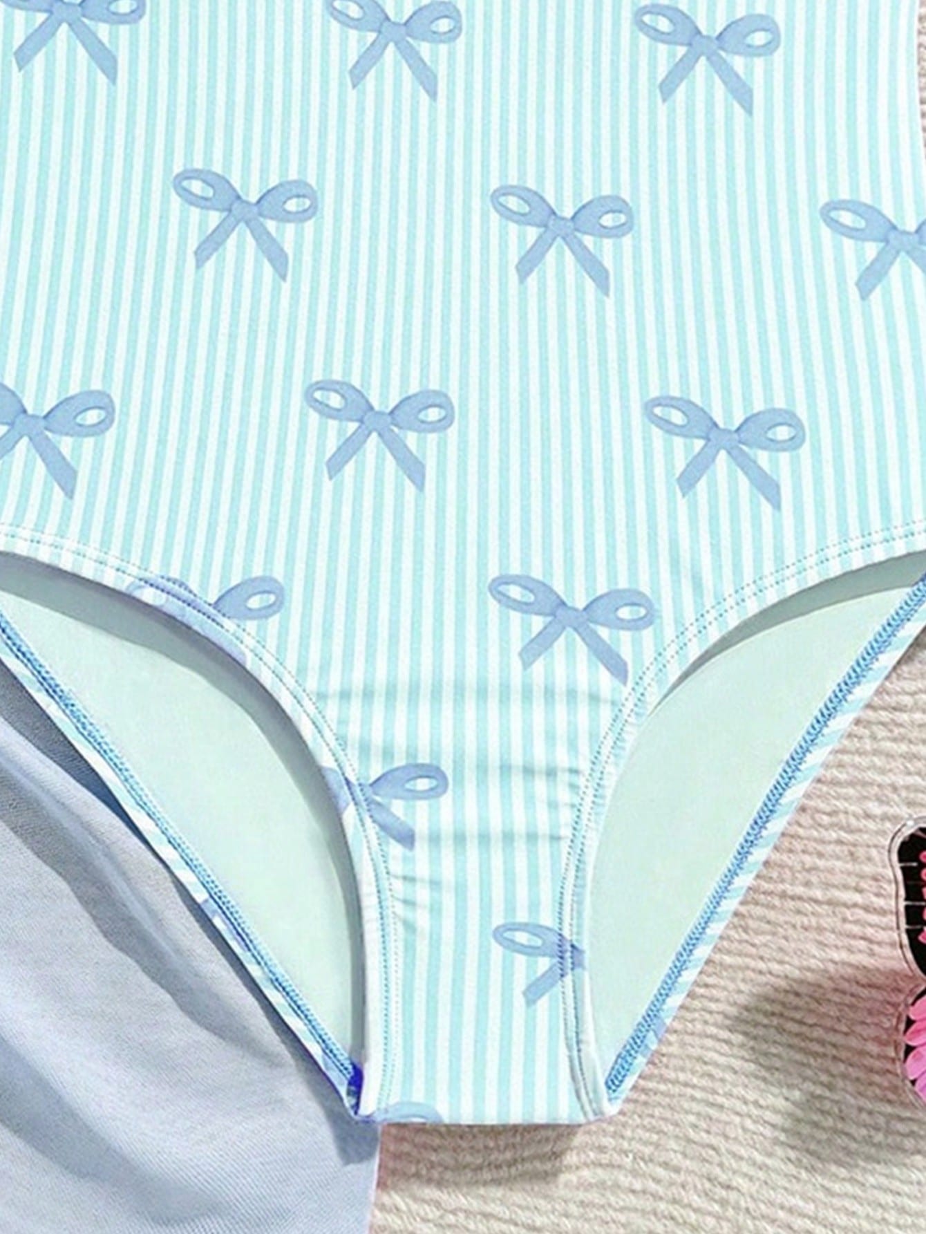 Tween girls one-piece swimsuit in leopard print with ruffle shoulder straps, scoop neckline, fitted shape, and attached ruffle hem skirt; sleeveless, mid-waist skirt bottom, and lined body for swimming, vacation, and summer beach wear.