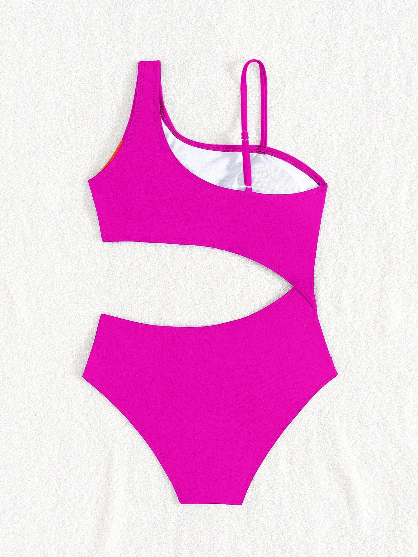 Black one-piece swimsuit for tween girls with cut out detail, spaghetti straps, high waist bottom, wireless bra, and fitted vacation swimwear style.