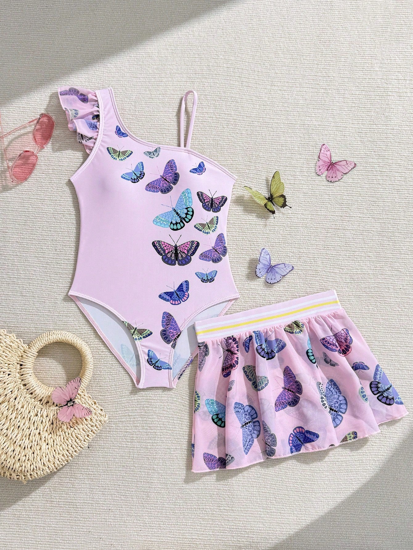 Girls yellow one-piece swimsuit with asymmetrical neckline, ruffle detail, sleeveless fitted style, and skirt bottom for beach and pool vacations.