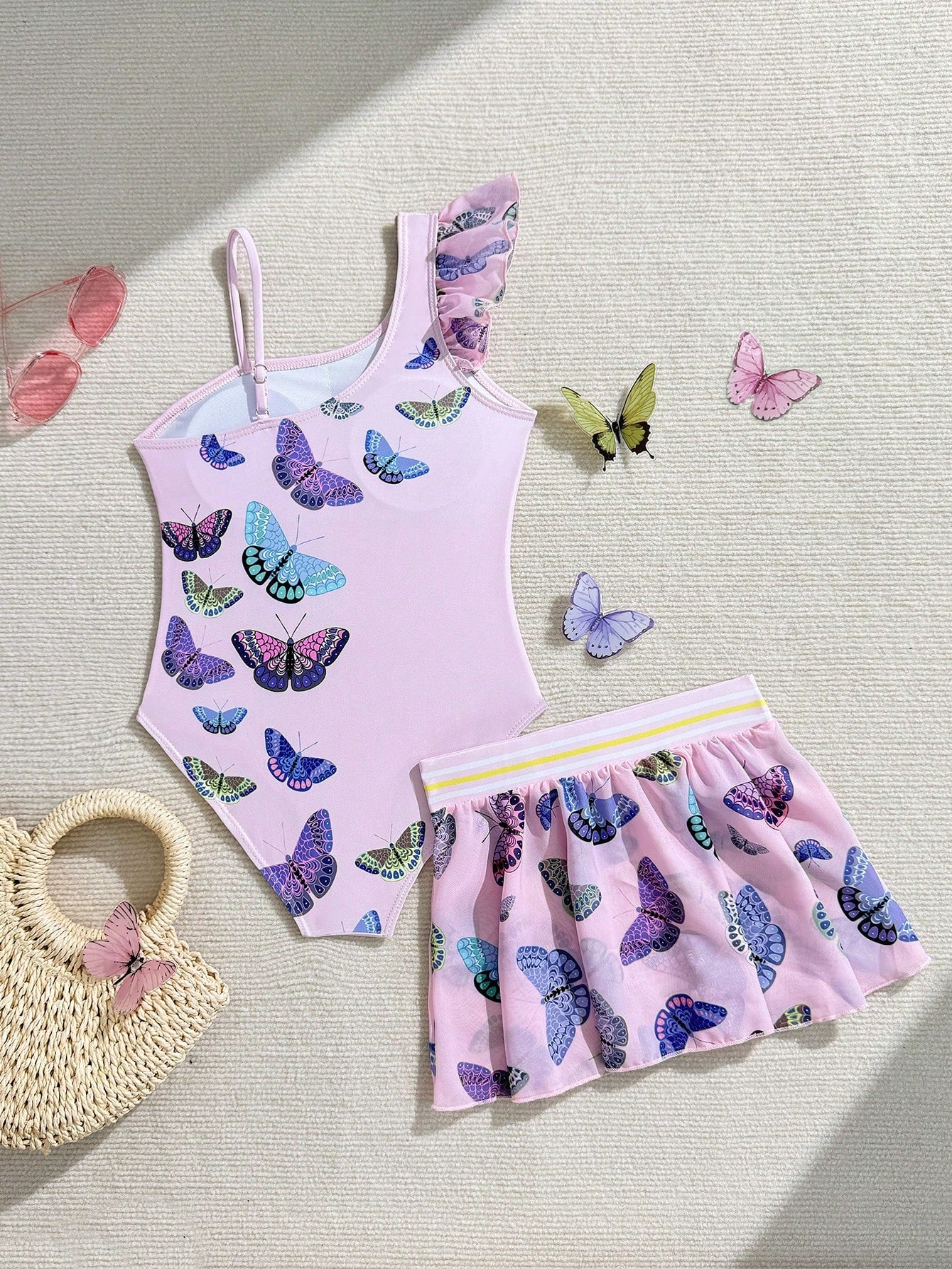 Girls yellow one-piece swimsuit with asymmetrical neckline, ruffle detail, sleeveless fitted style, and skirt bottom for beach and pool vacations.