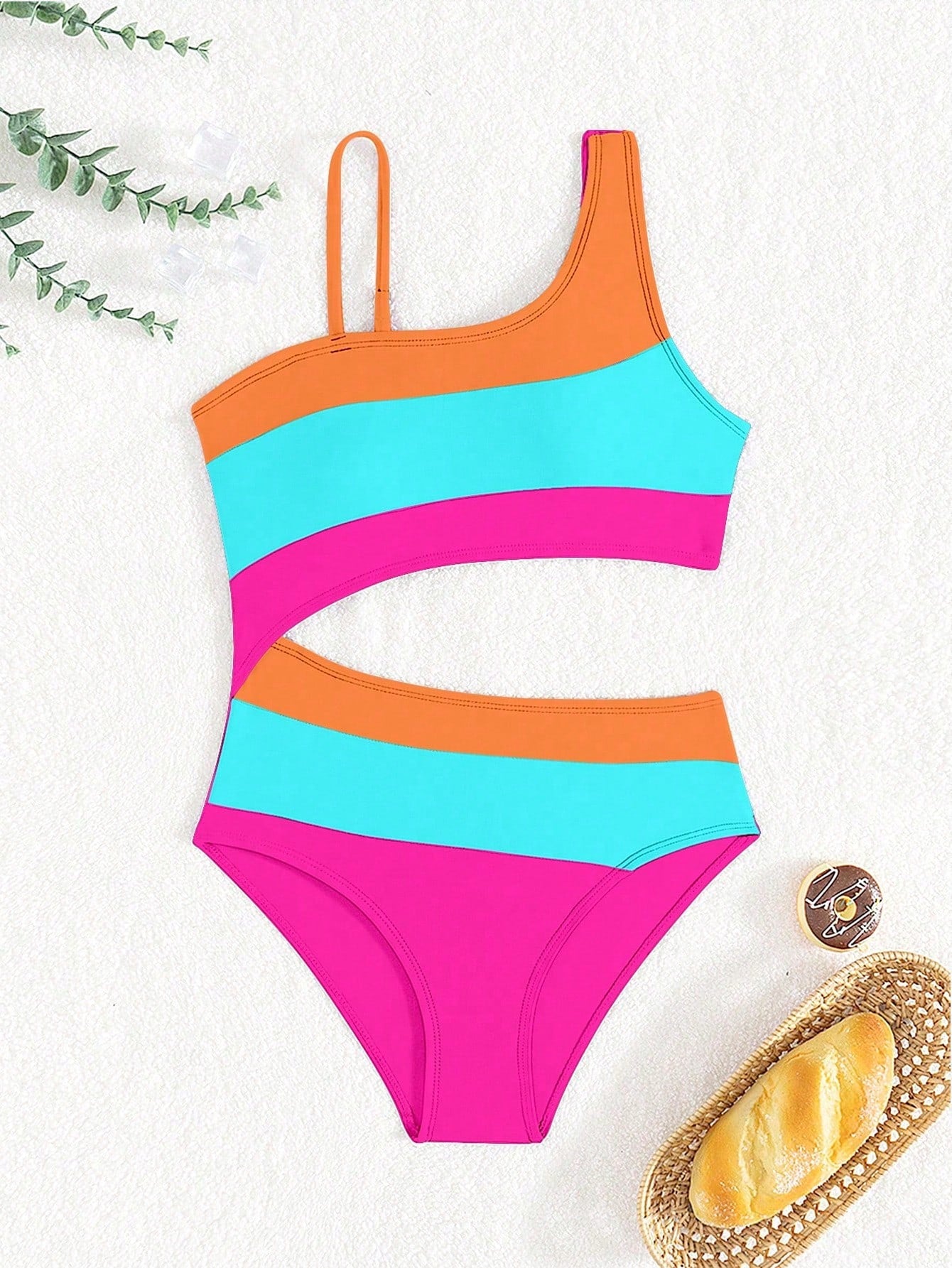 Black one-piece swimsuit for tween girls with cut out detail, spaghetti straps, high waist bottom, wireless bra, and fitted vacation swimwear style.