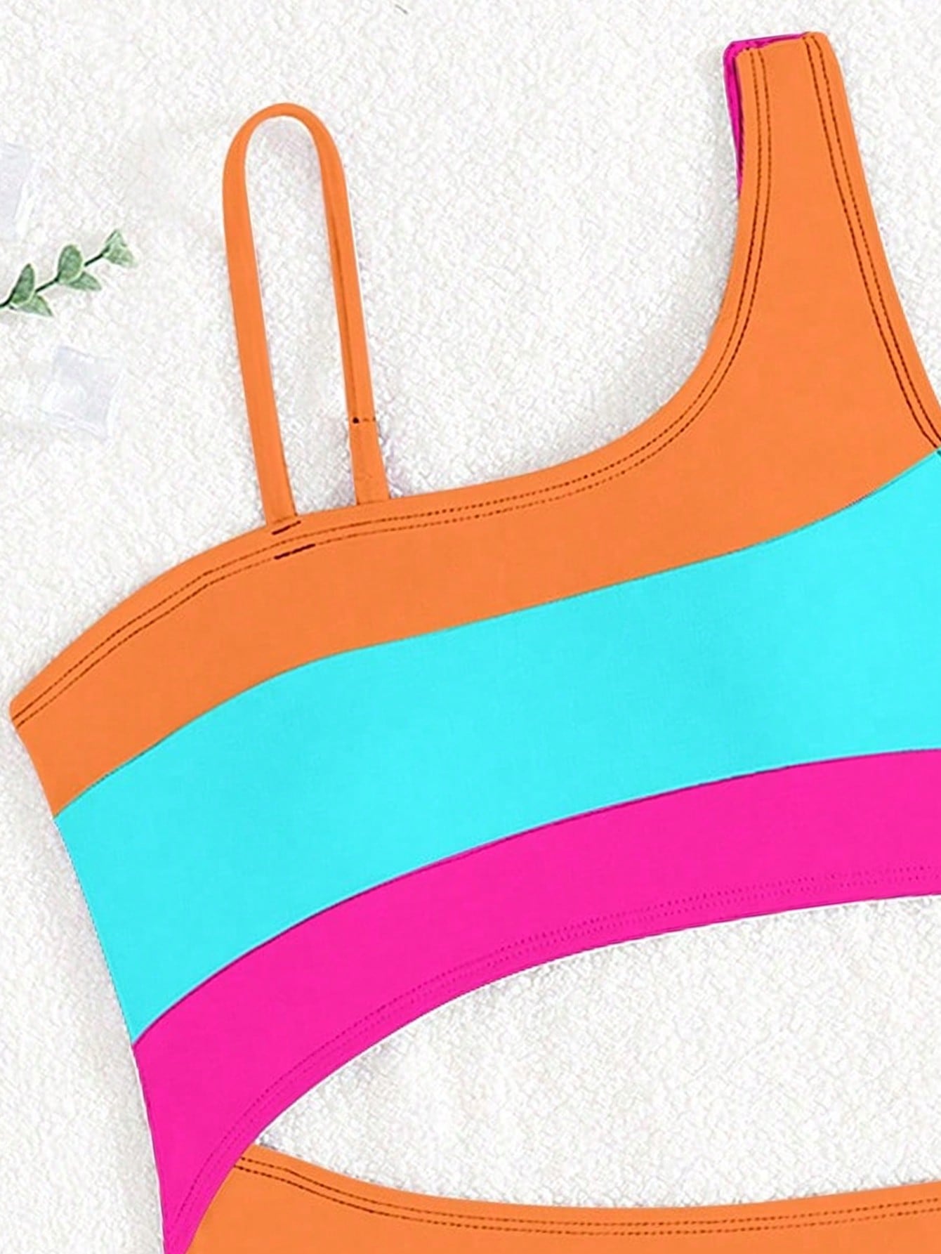 Black one-piece swimsuit for tween girls with cut out detail, spaghetti straps, high waist bottom, wireless bra, and fitted vacation swimwear style.