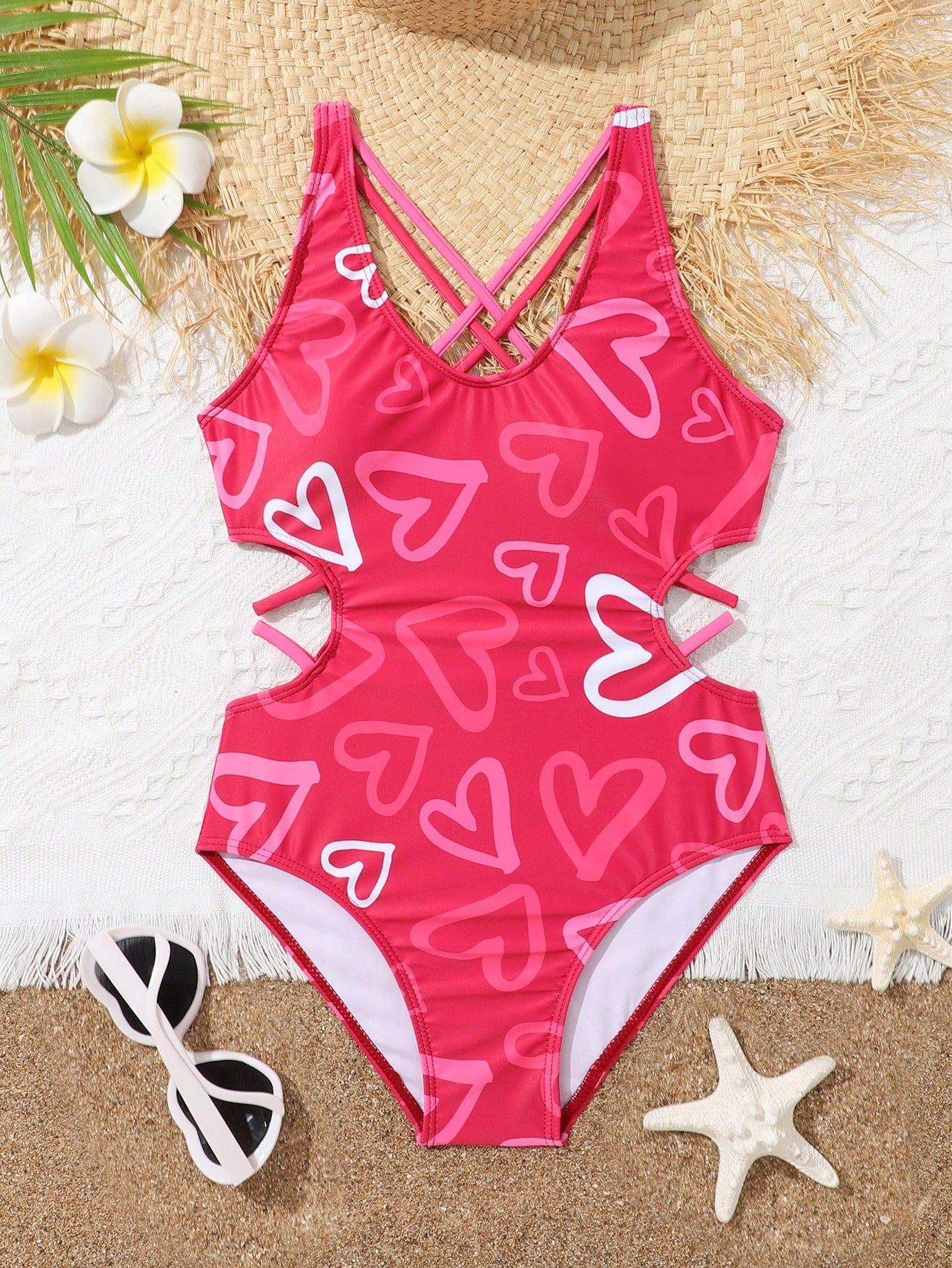 Tween girl multicolor one-piece swimsuit with gradient heart graphic print, scoop neck, cutout detail, and fitted vacation beachwear style.