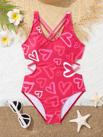 Tween girl multicolor one-piece swimsuit with gradient heart graphic print, scoop neck, cutout detail, and fitted vacation beachwear style.