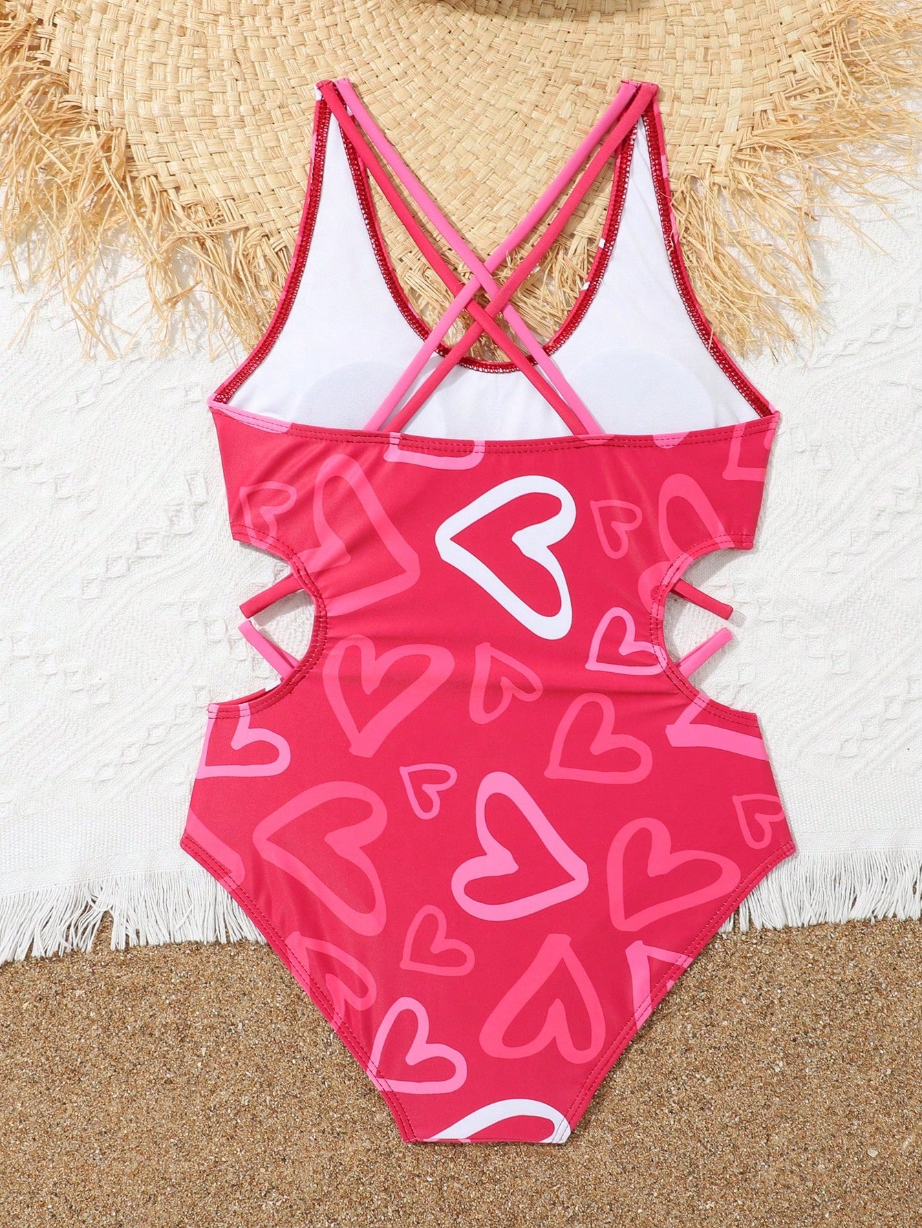 Tween girl multicolor one-piece swimsuit with gradient heart graphic print, scoop neck, cutout detail, and fitted vacation beachwear style.