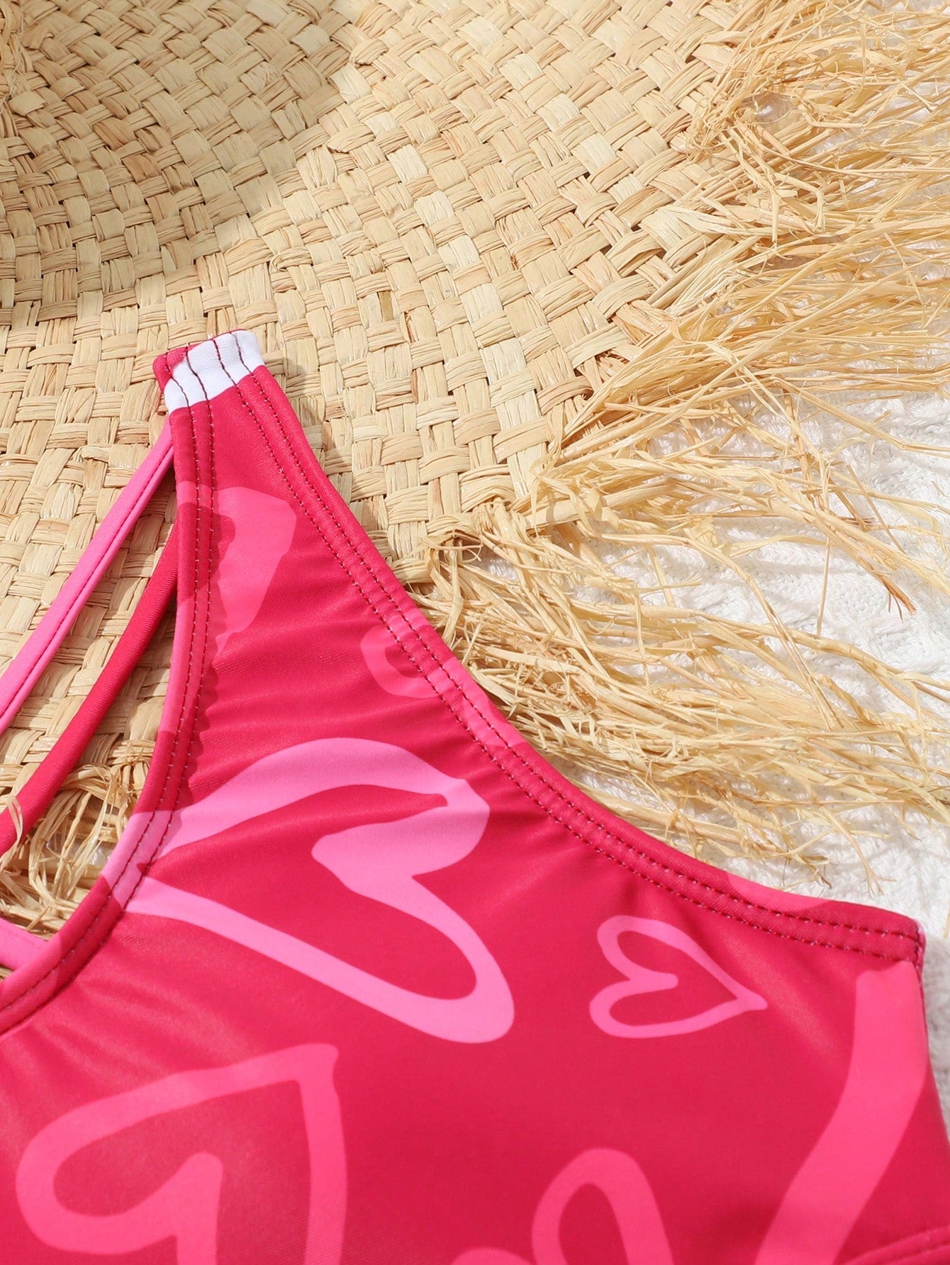 Tween girl multicolor one-piece swimsuit with gradient heart graphic print, scoop neck, cutout detail, and fitted vacation beachwear style.