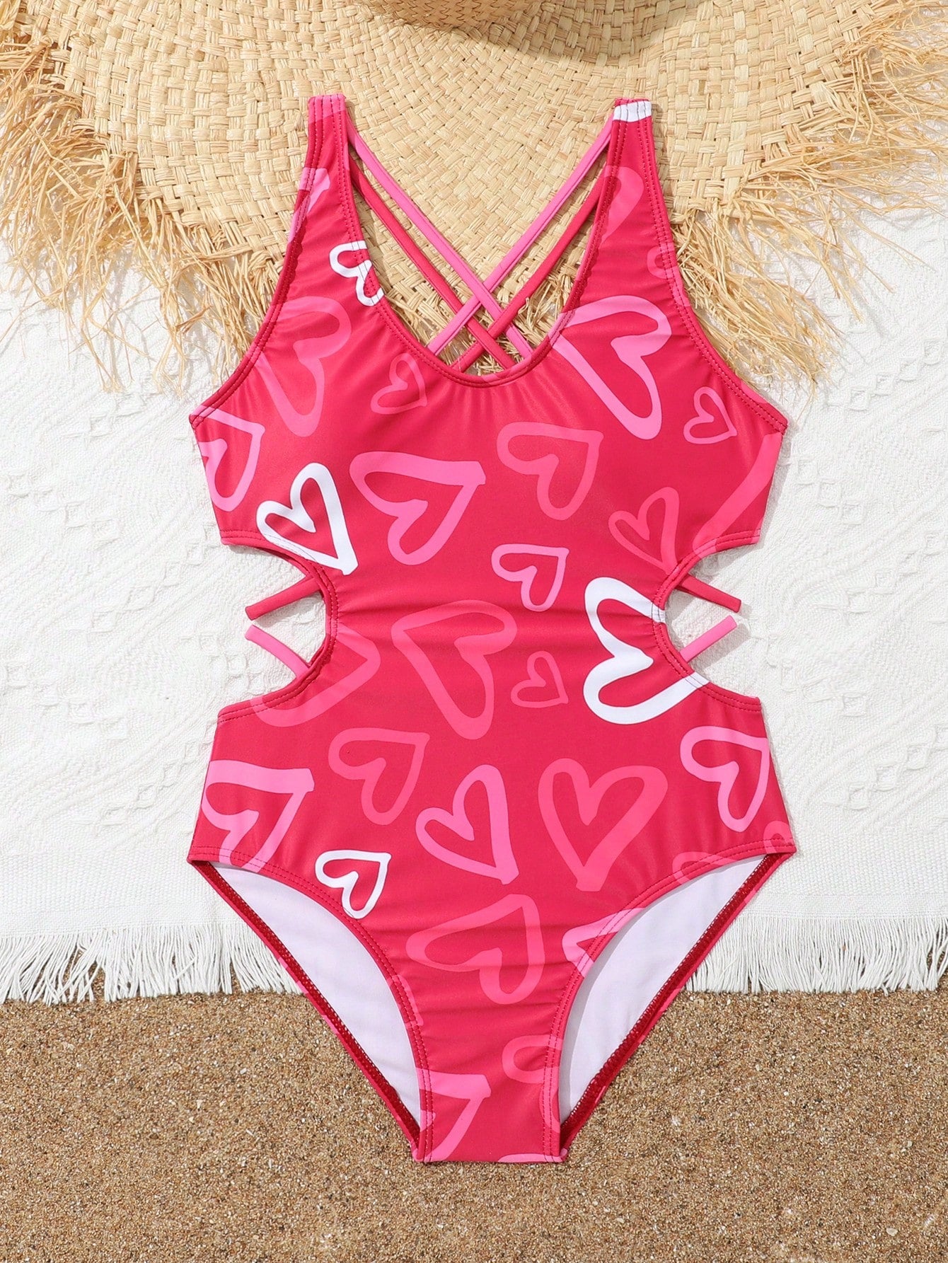Tween girl multicolor one-piece swimsuit with gradient heart graphic print, scoop neck, cutout detail, and fitted vacation beachwear style.