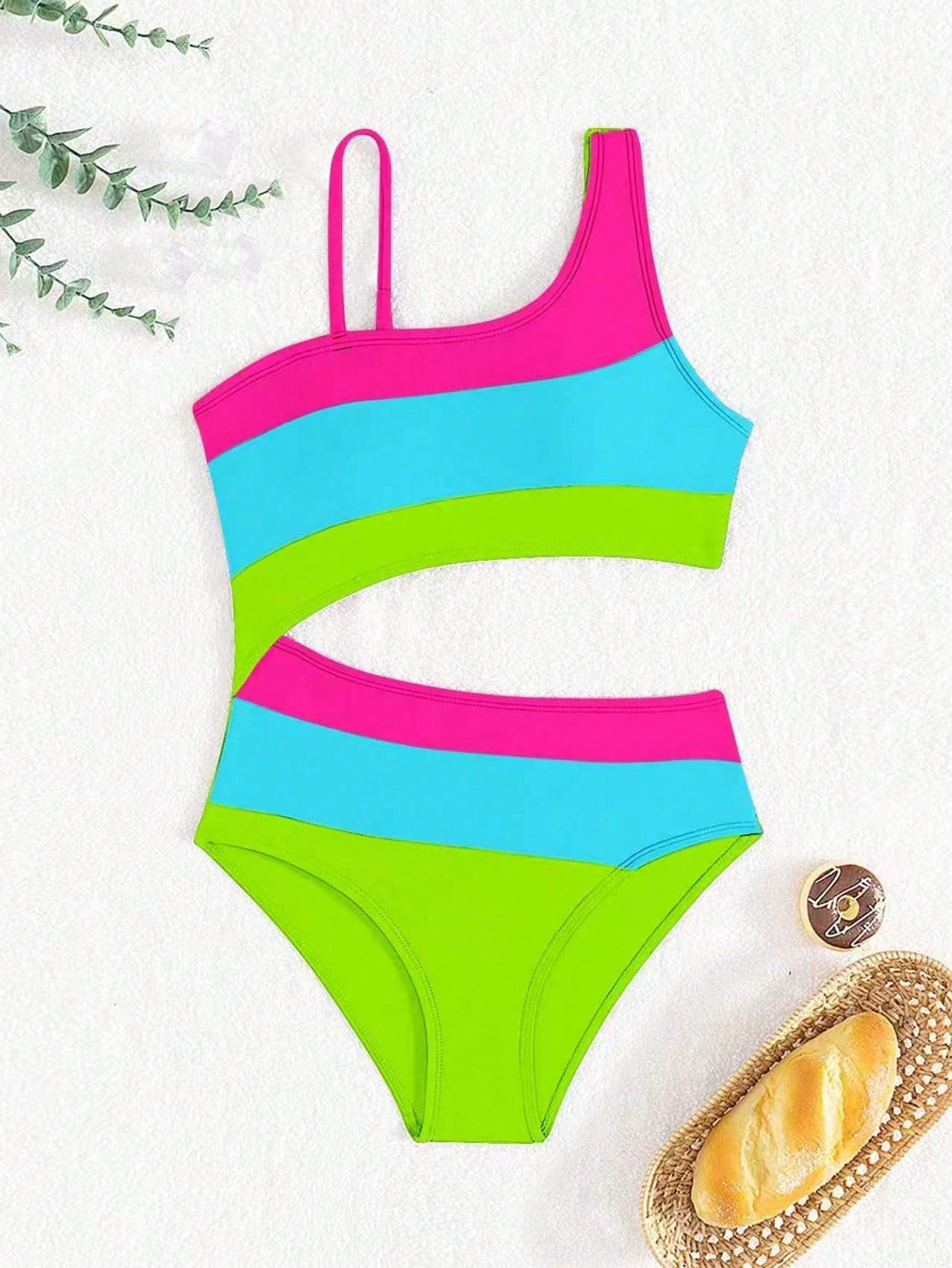 Black one-piece swimsuit for tween girls with cut out detail, spaghetti straps, high waist bottom, wireless bra, and fitted vacation swimwear style.