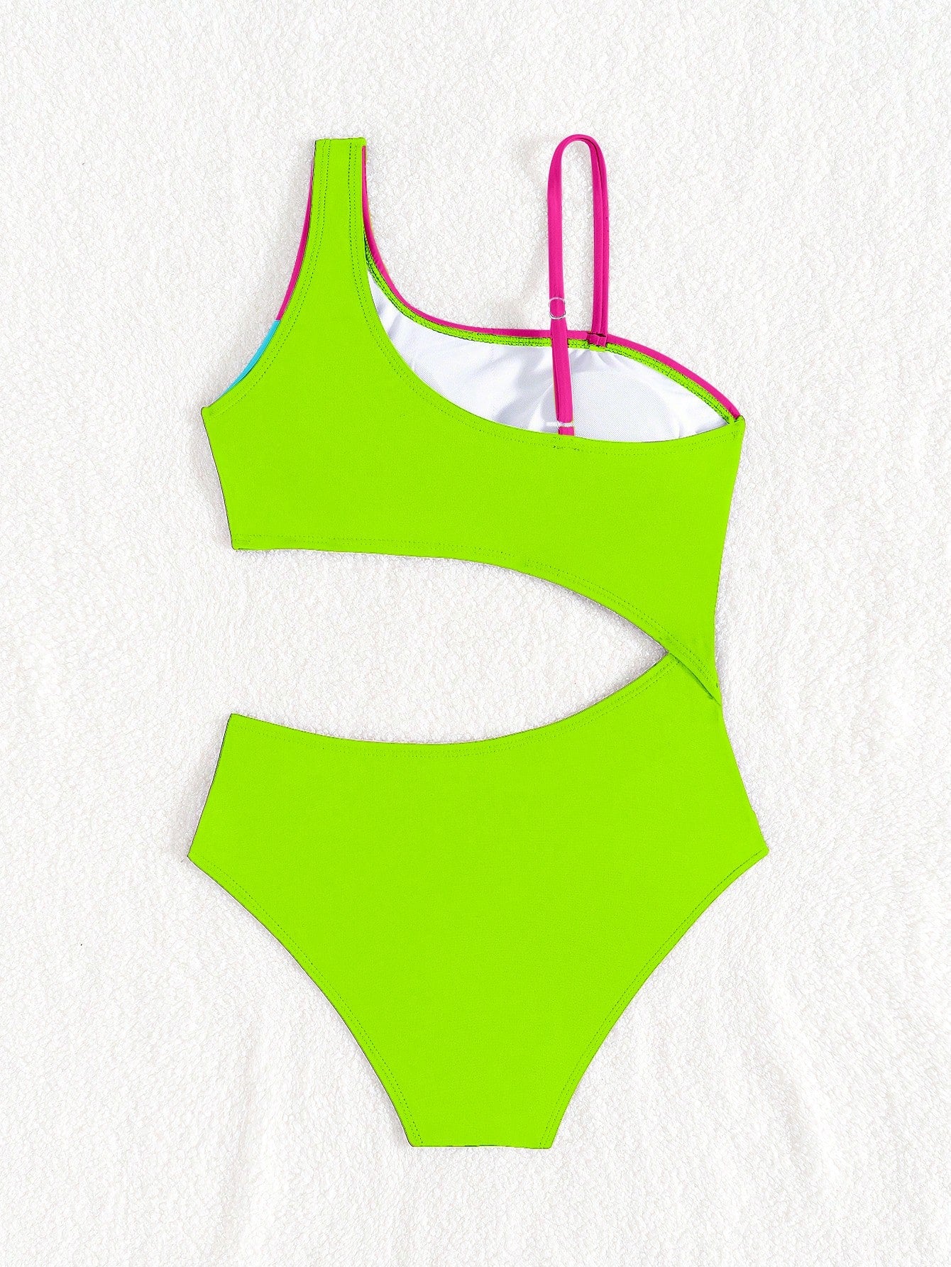 Black one-piece swimsuit for tween girls with cut out detail, spaghetti straps, high waist bottom, wireless bra, and fitted vacation swimwear style.