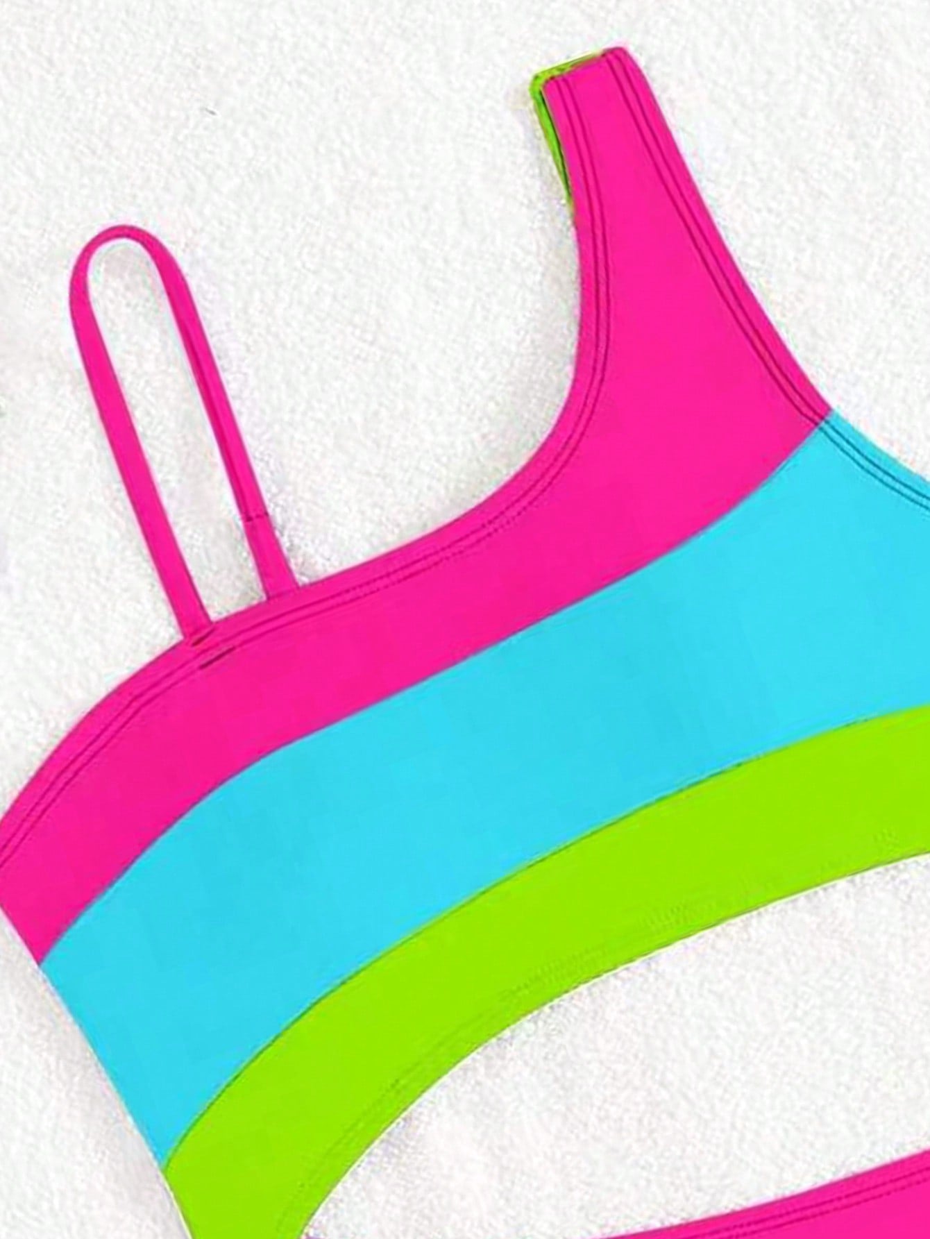 Black one-piece swimsuit for tween girls with cut out detail, spaghetti straps, high waist bottom, wireless bra, and fitted vacation swimwear style.