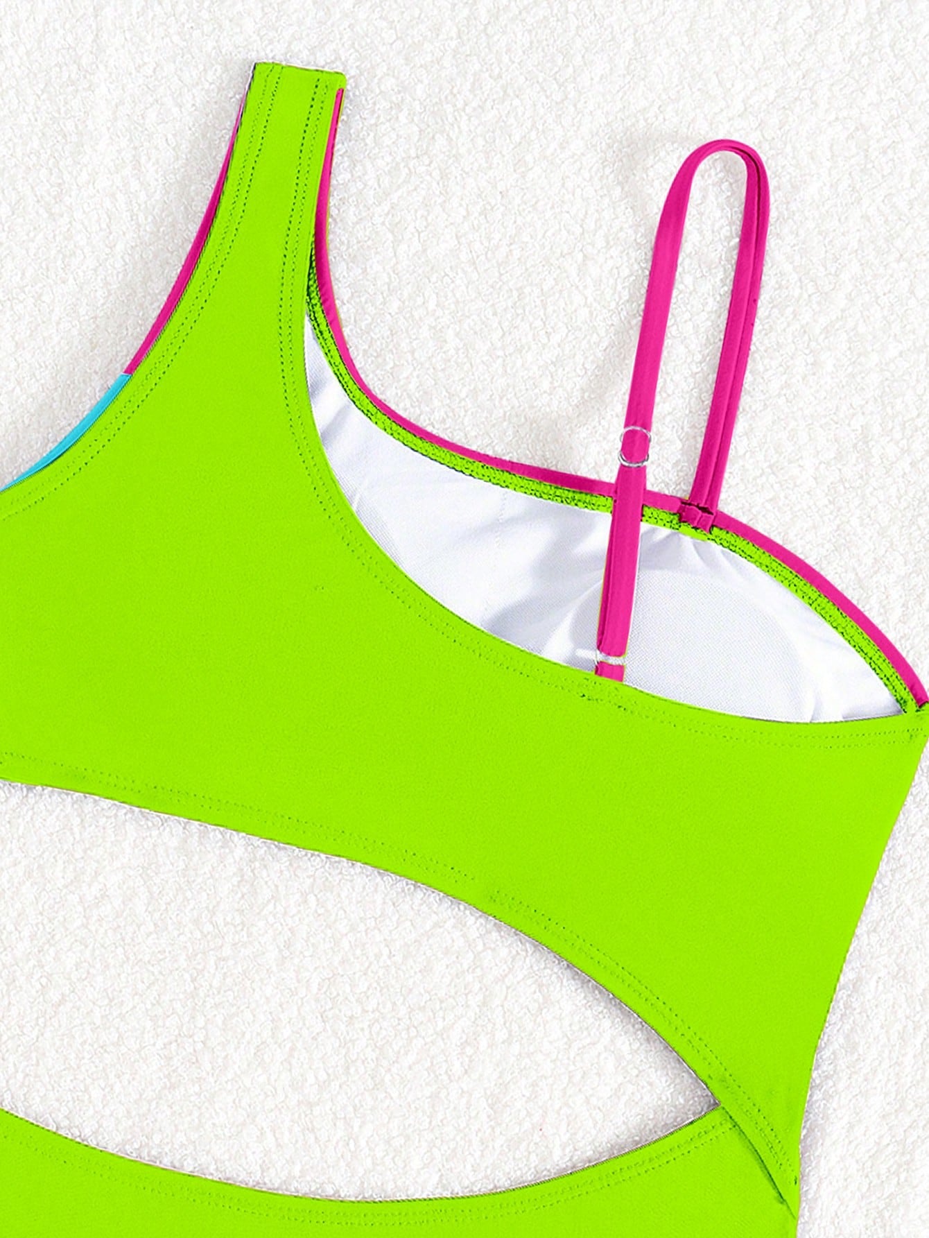 Black one-piece swimsuit for tween girls with cut out detail, spaghetti straps, high waist bottom, wireless bra, and fitted vacation swimwear style.