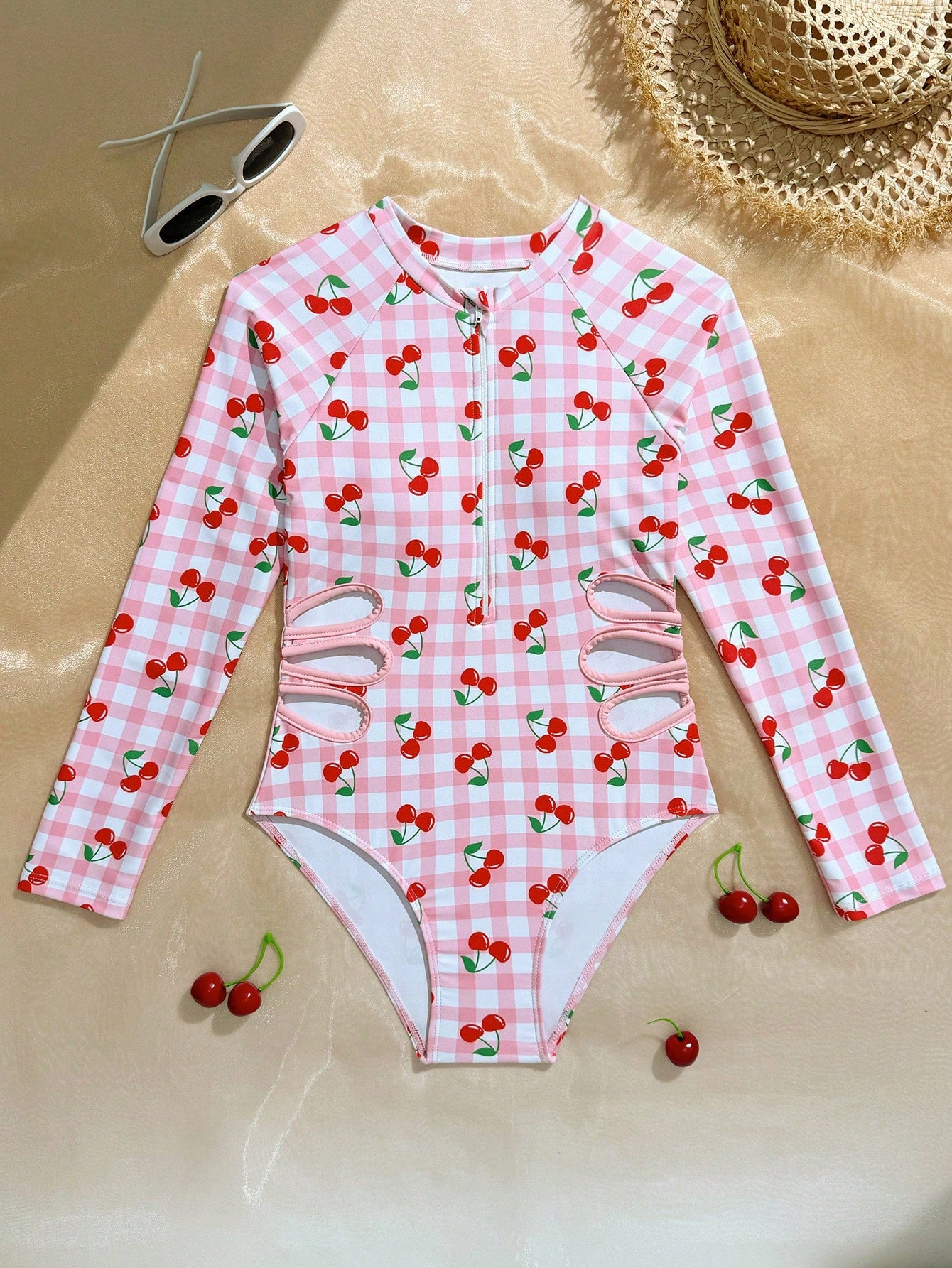 Purple tween girls one-piece swimsuit with graphic striped print, ruffle detail, round neck, and zipper closure for swimming and vacation wear