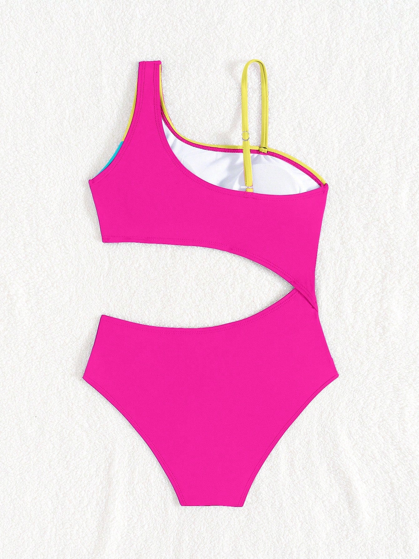 Black one-piece swimsuit for tween girls with cut out detail, spaghetti straps, high waist bottom, wireless bra, and fitted vacation swimwear style.