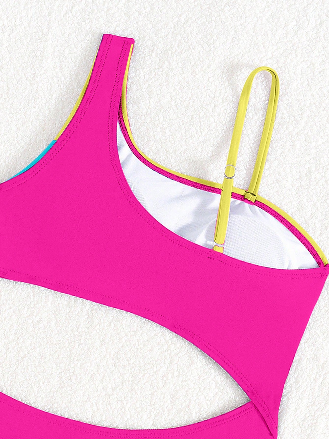 Black one-piece swimsuit for tween girls with cut out detail, spaghetti straps, high waist bottom, wireless bra, and fitted vacation swimwear style.