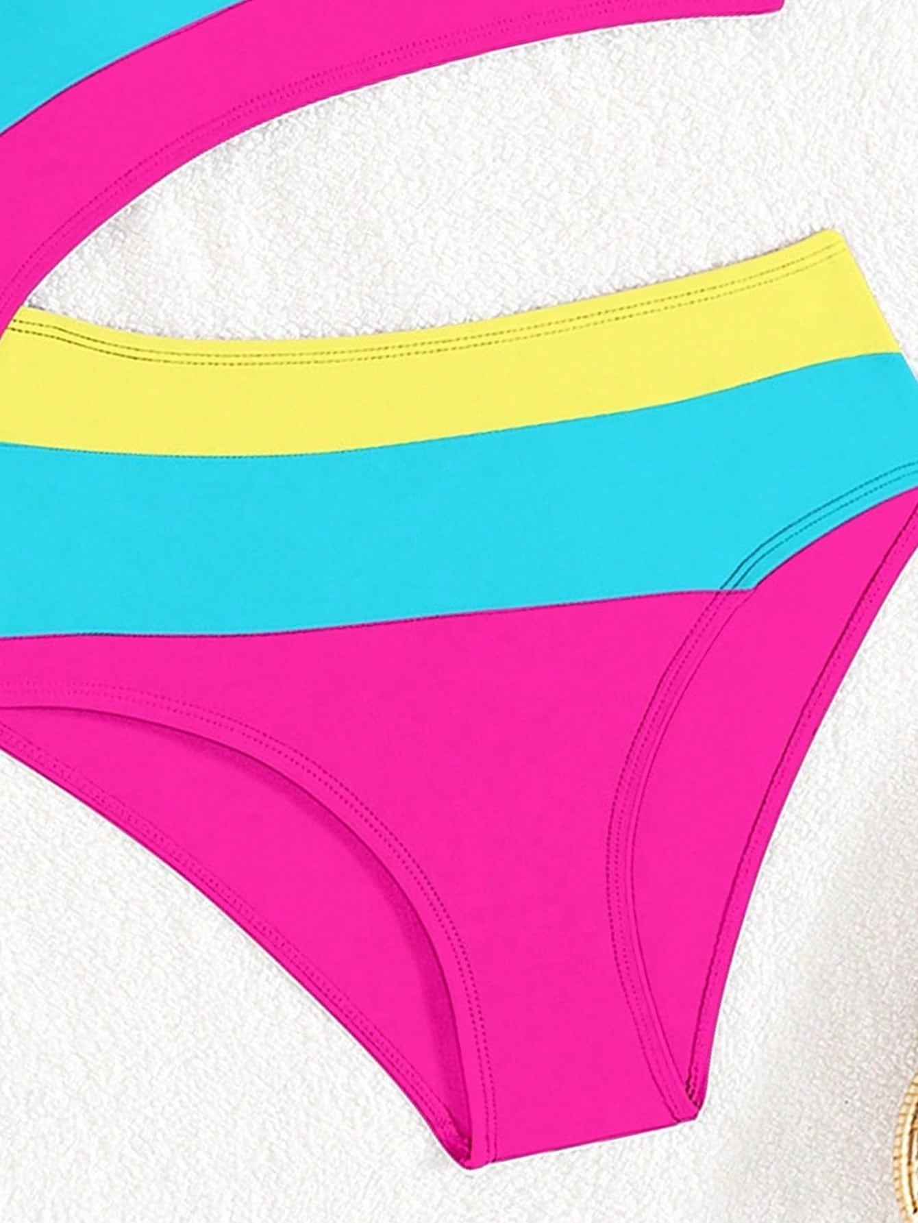 Black one-piece swimsuit for tween girls with cut out detail, spaghetti straps, high waist bottom, wireless bra, and fitted vacation swimwear style.
