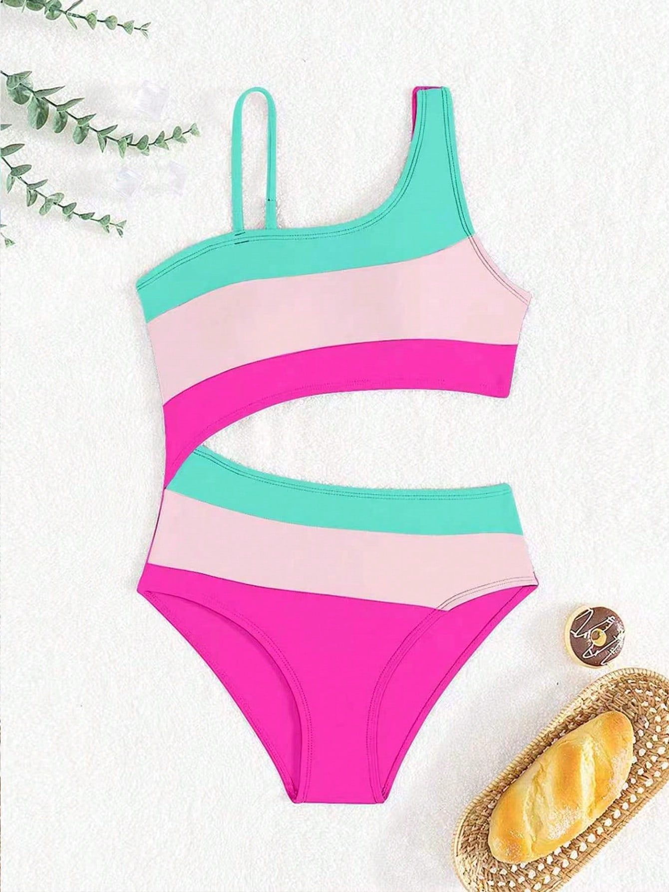 Black one-piece swimsuit for tween girls with cut out detail, spaghetti straps, high waist bottom, wireless bra, and fitted vacation swimwear style.