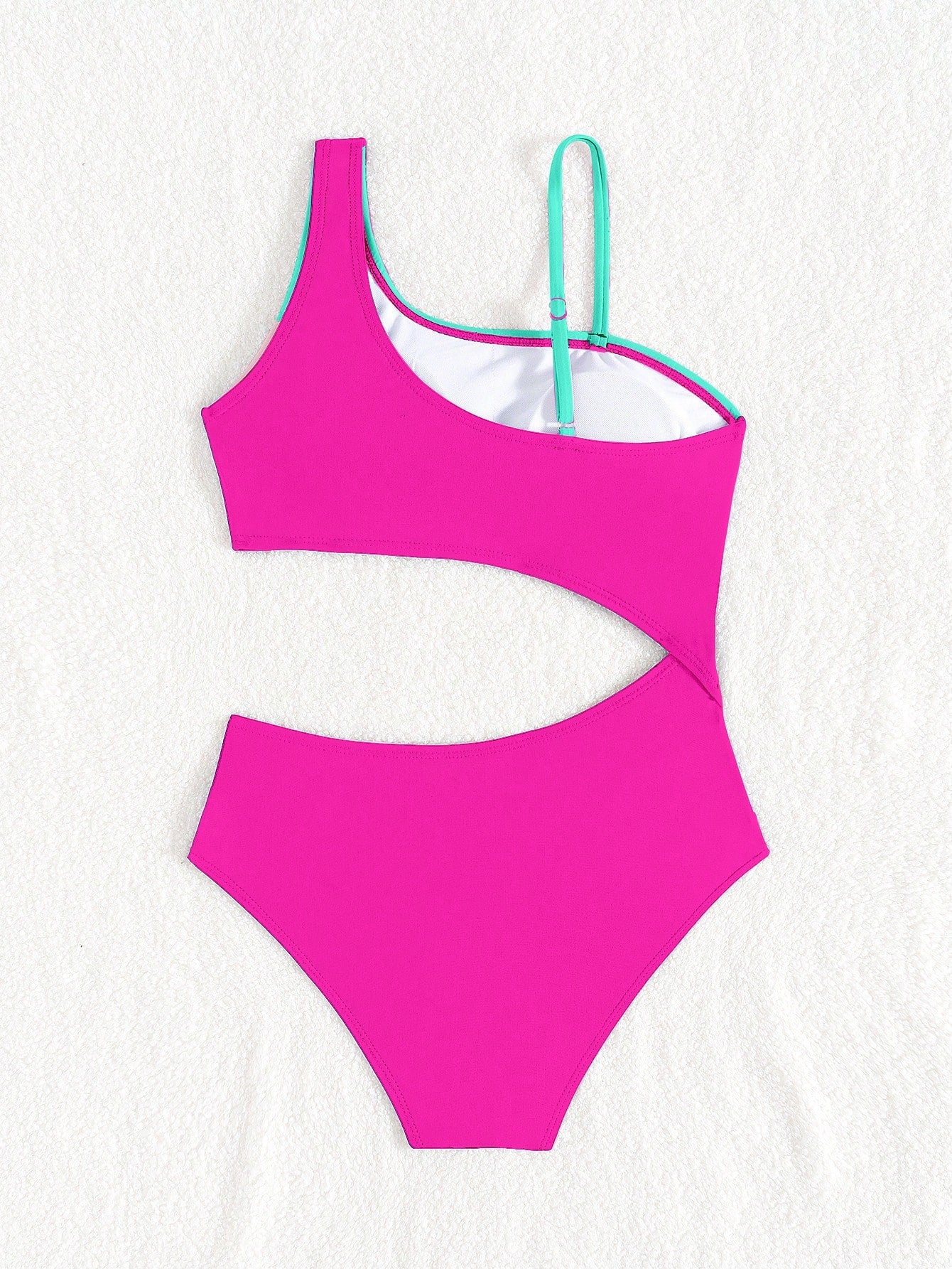 Black one-piece swimsuit for tween girls with cut out detail, spaghetti straps, high waist bottom, wireless bra, and fitted vacation swimwear style.