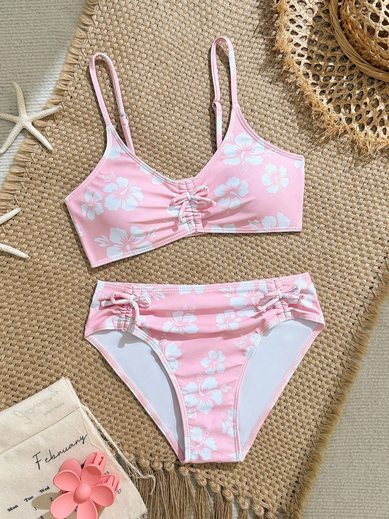 Tween girls 2-piece ditsy floral bikini set featuring a spaghetti strap top with center string detail and matching bottoms with side strings, designed for swimming, vacation, and summer wear.