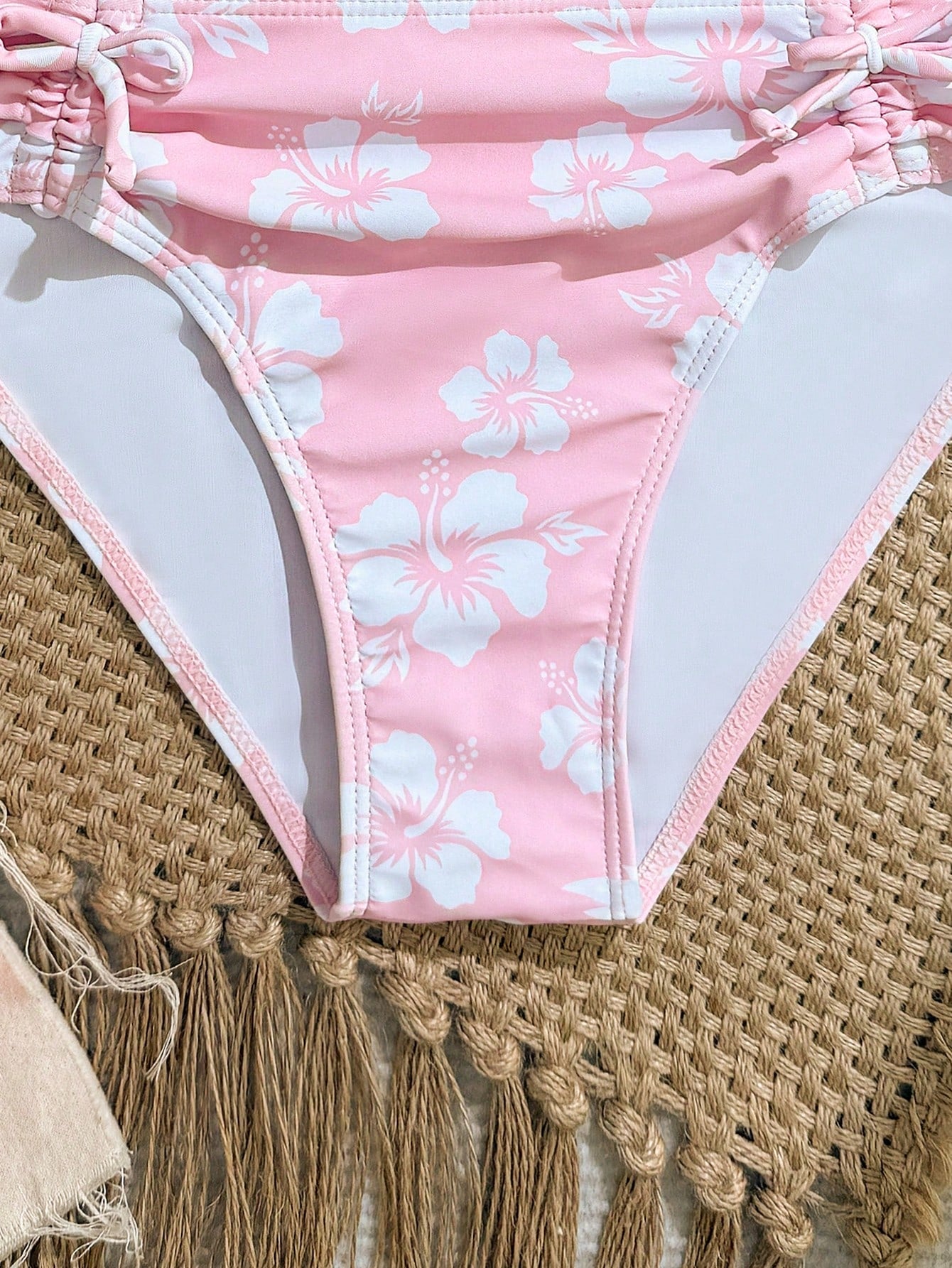 Tween girls 2-piece ditsy floral bikini set featuring a spaghetti strap top with center string detail and matching bottoms with side strings, designed for swimming, vacation, and summer wear.