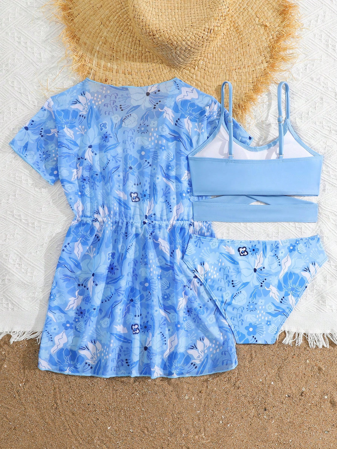 Three-piece tween girls swimwear set with a floral print, featuring a criss-cross bikini top, regular bikini bottoms, and a kimono cover-up in assorted prints.