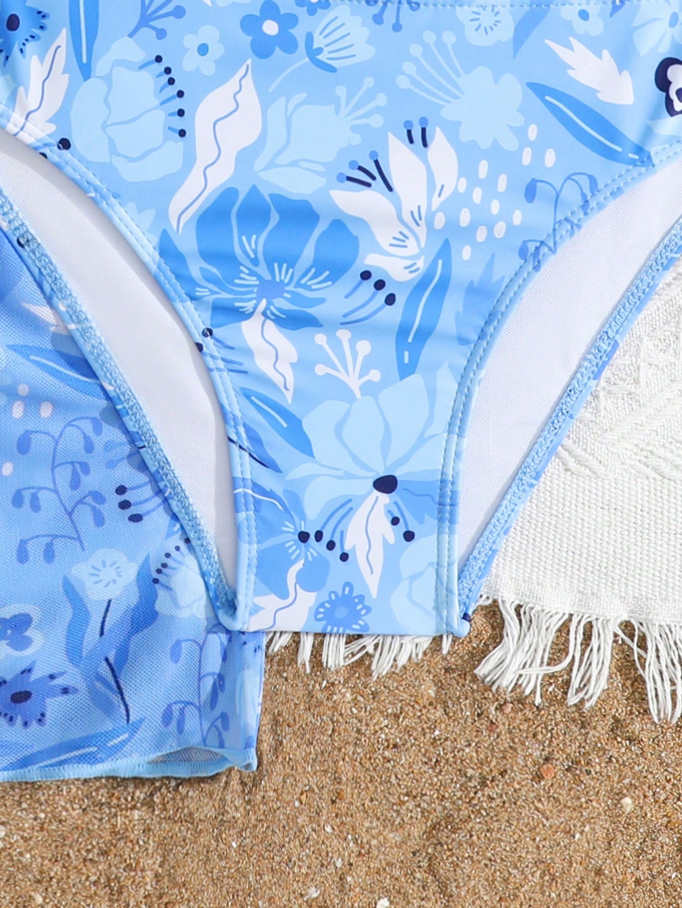 Three-piece tween girls swimwear set with a floral print, featuring a criss-cross bikini top, regular bikini bottoms, and a kimono cover-up in assorted prints.