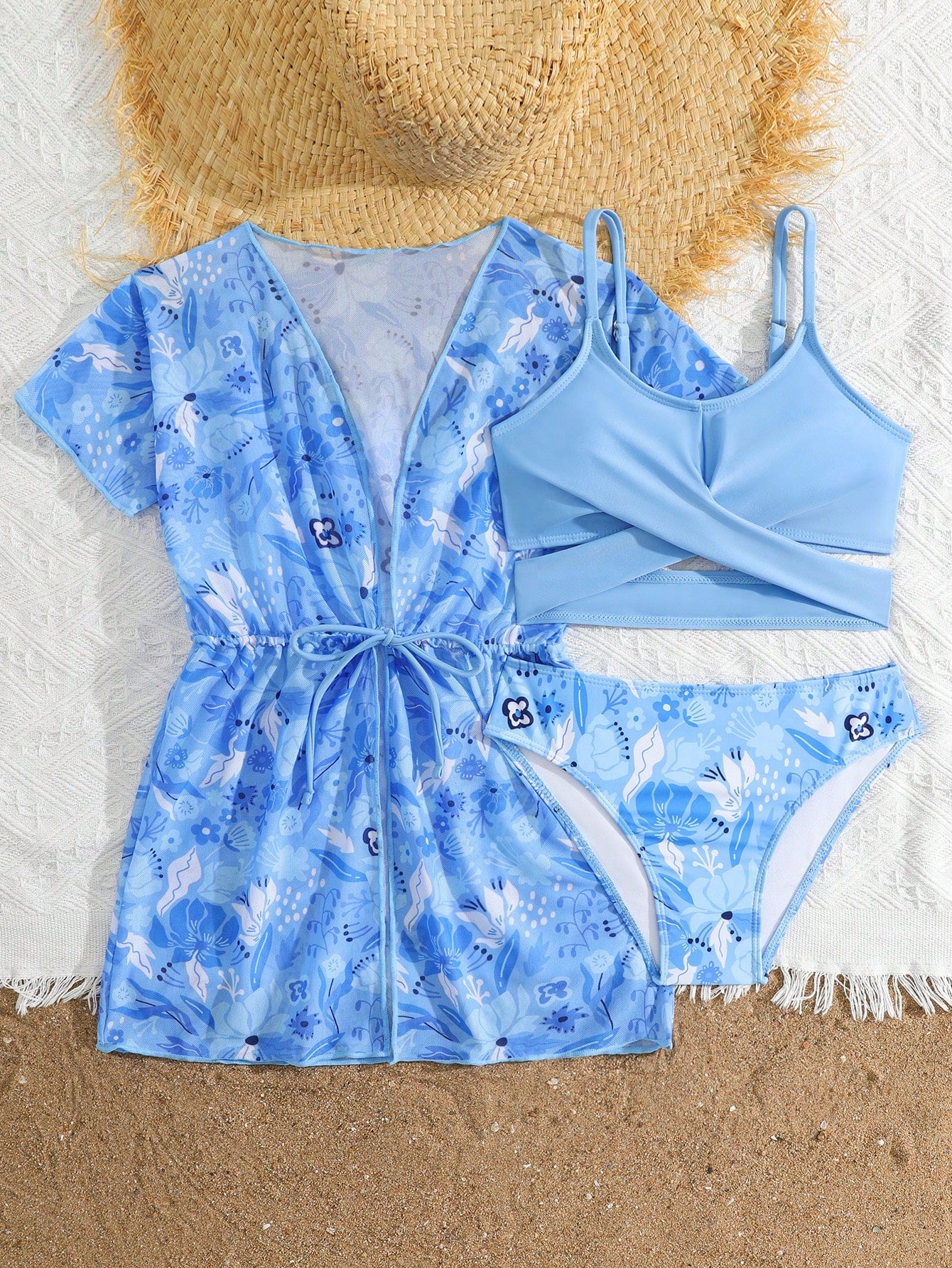 Three-piece tween girls swimwear set with a floral print, featuring a criss-cross bikini top, regular bikini bottoms, and a kimono cover-up in assorted prints.