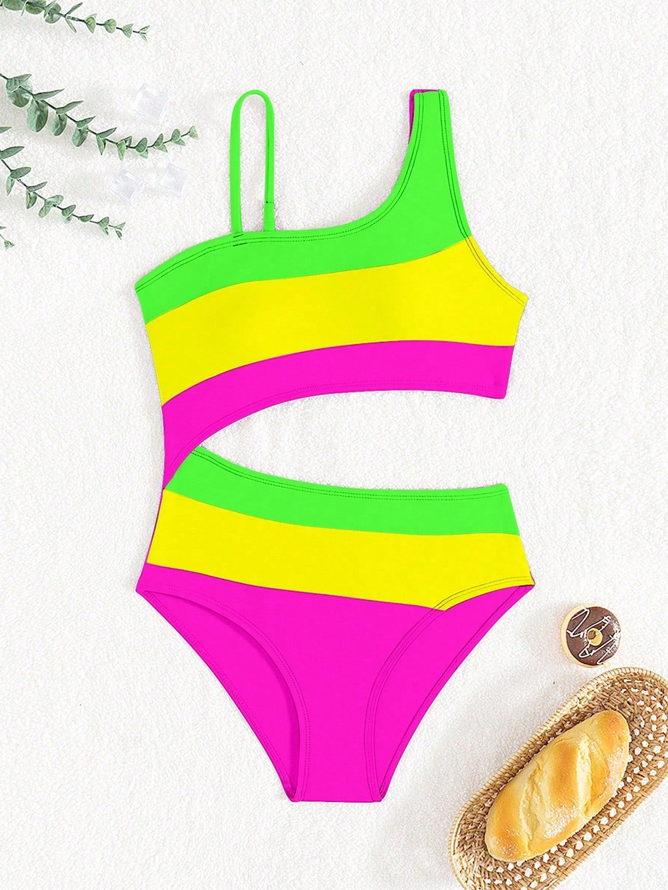 Black one-piece swimsuit for tween girls with cut out detail, spaghetti straps, high waist bottom, wireless bra, and fitted vacation swimwear style.