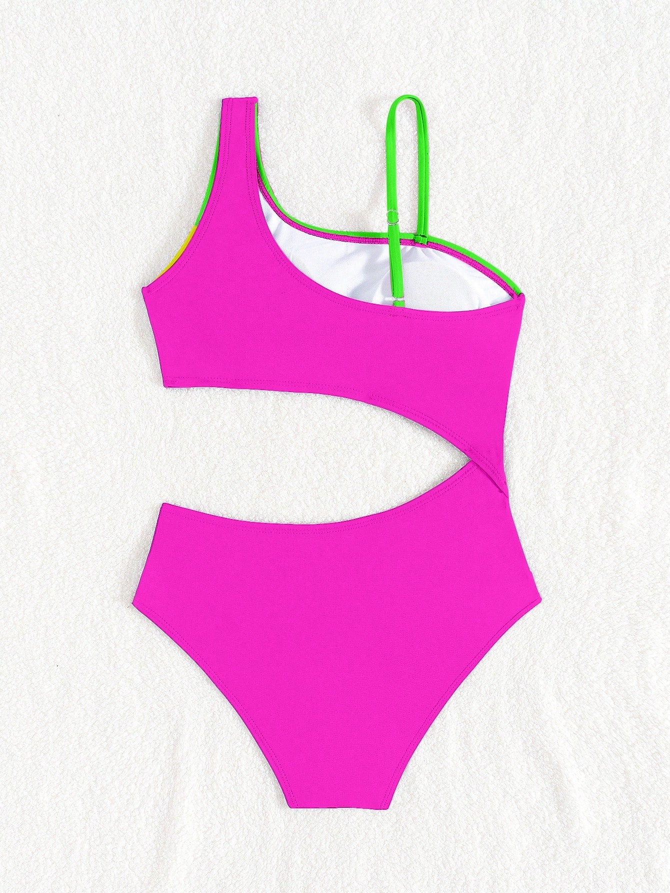 Black one-piece swimsuit for tween girls with cut out detail, spaghetti straps, high waist bottom, wireless bra, and fitted vacation swimwear style.