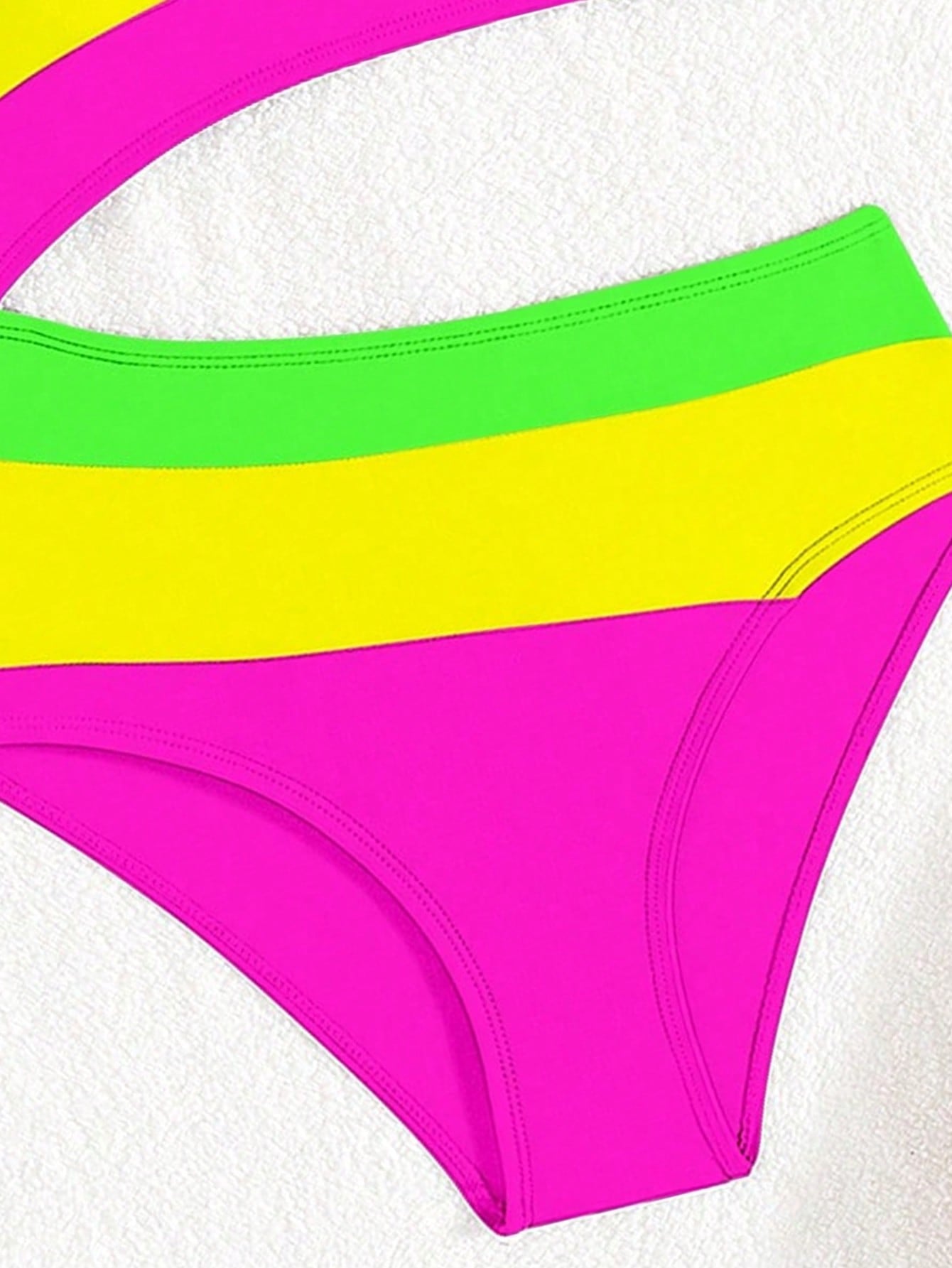 Black one-piece swimsuit for tween girls with cut out detail, spaghetti straps, high waist bottom, wireless bra, and fitted vacation swimwear style.