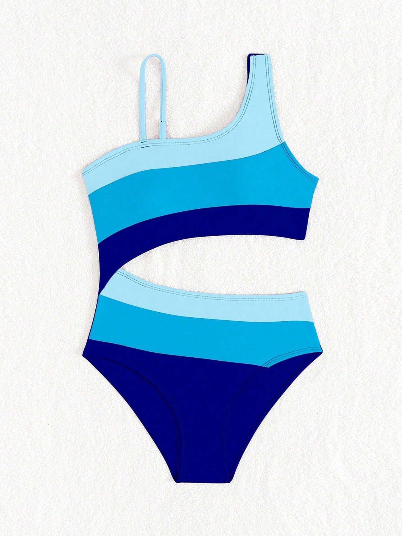 Black one-piece swimsuit for tween girls with cut out detail, spaghetti straps, high waist bottom, wireless bra, and fitted vacation swimwear style.