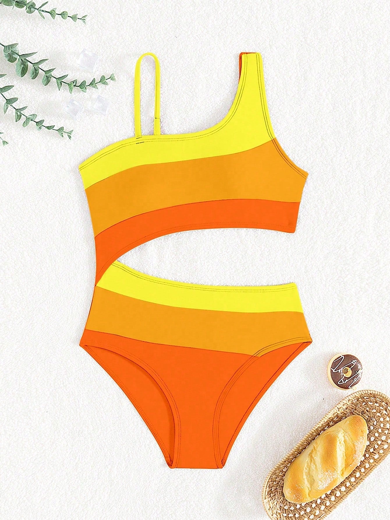 Black one-piece swimsuit for tween girls with cut out detail, spaghetti straps, high waist bottom, wireless bra, and fitted vacation swimwear style.