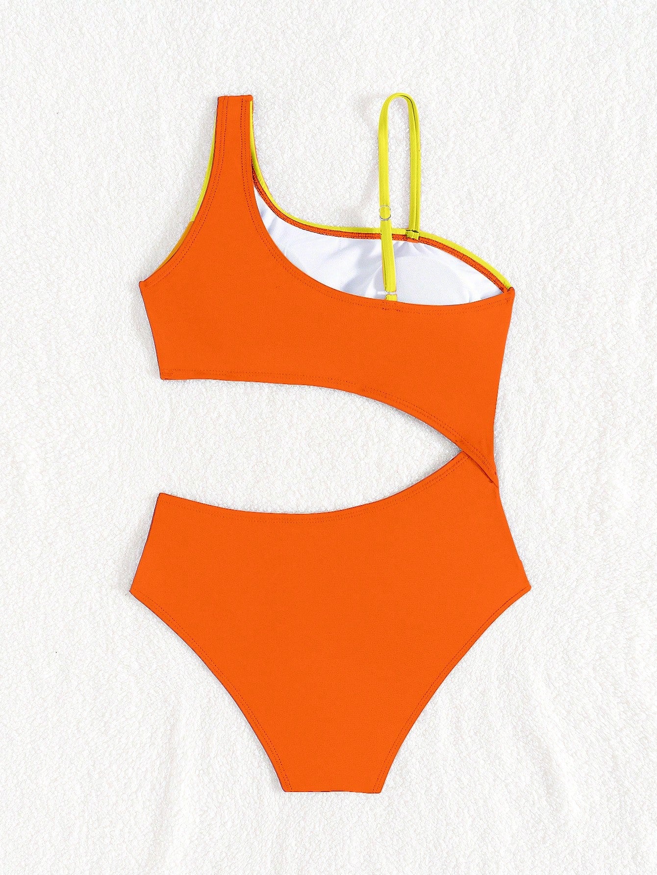 Black one-piece swimsuit for tween girls with cut out detail, spaghetti straps, high waist bottom, wireless bra, and fitted vacation swimwear style.